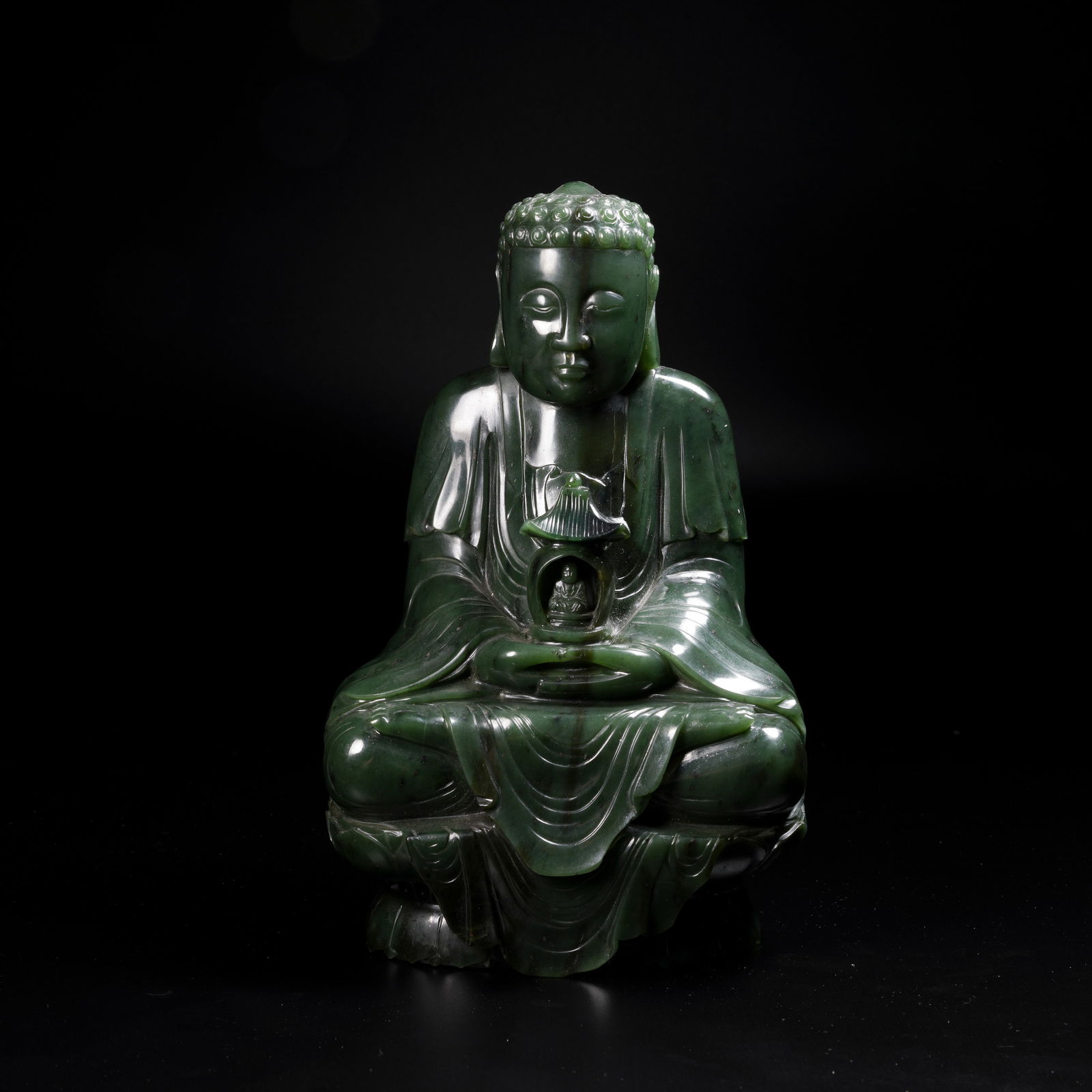 A HETIAN GREEN JADE SHAKYAMUNI SEATED FIGURE: Hetian Green Jade Shakyamuni Seated Figure