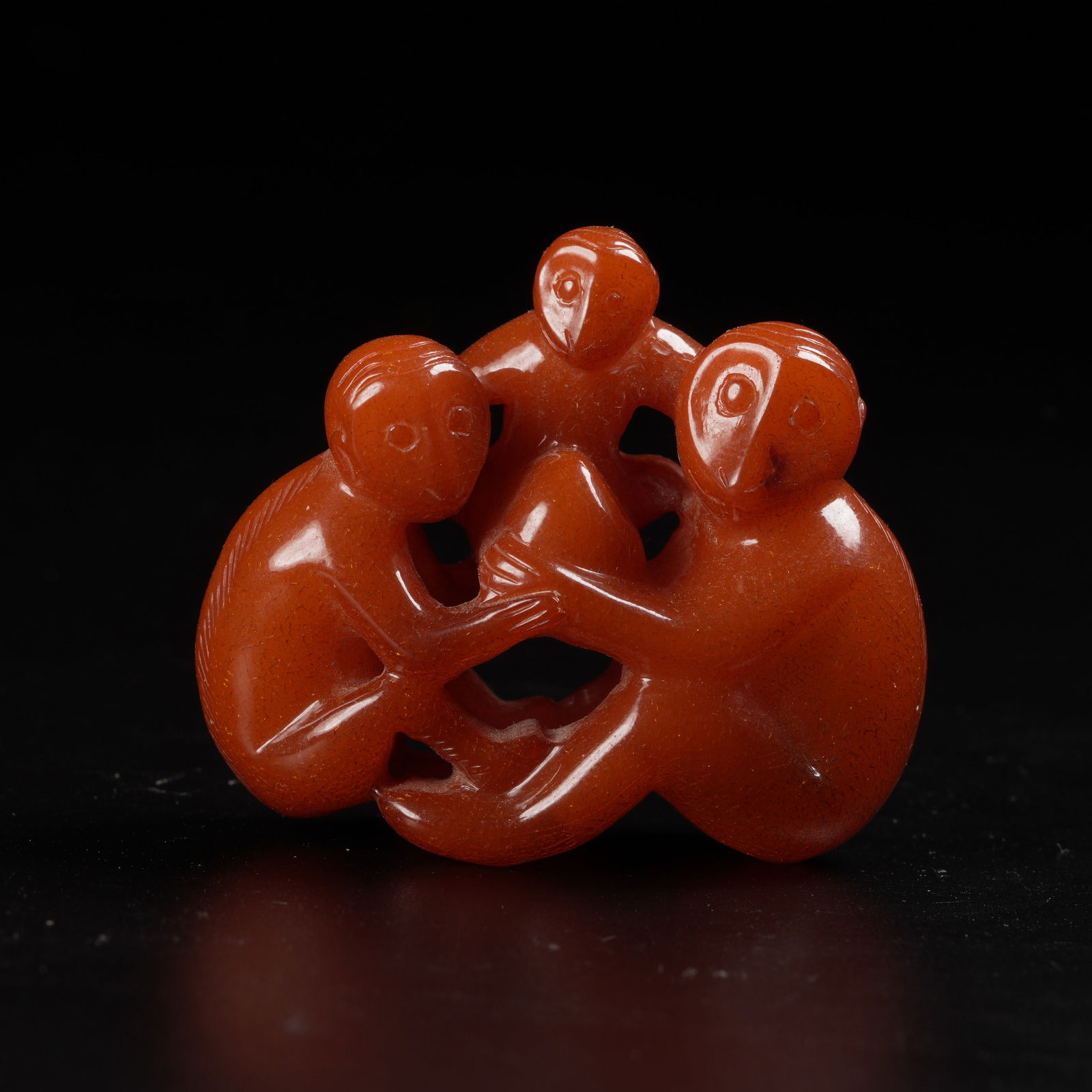 A HONEY-AMBER MONKEY PRESENTING LONGEVITY FIGURE: Honey-amber monkey presenting longevity figure