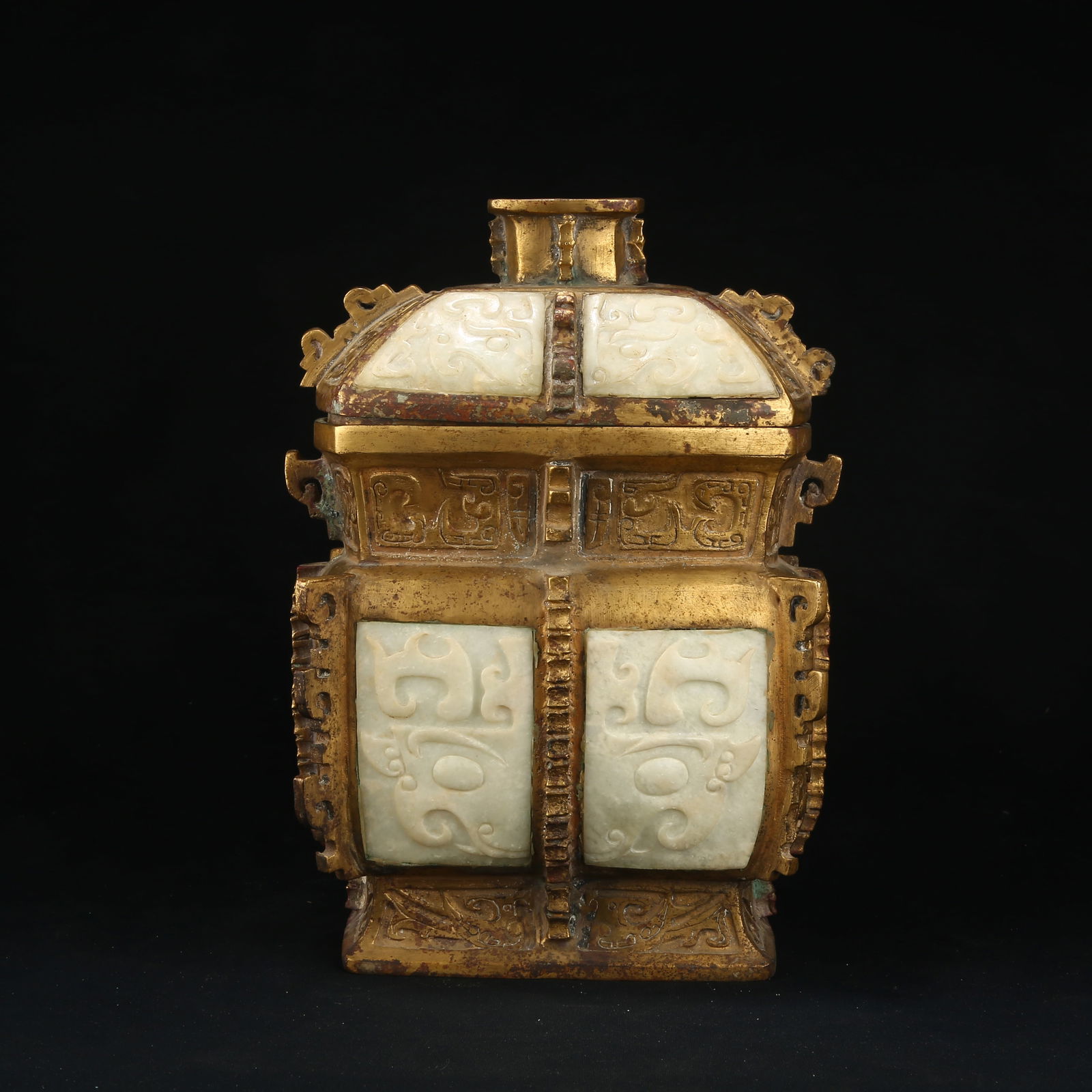 A GILT BRONZE FANG YI RITUAL VESSEL WITH PROTRUDING FLANGES AND INLAID JADE TAOTIE DESIGN: Gilt Bronze Fang Yi Ritual Vessel with Protruding Flanges and Inlaid Jade Taotie Design