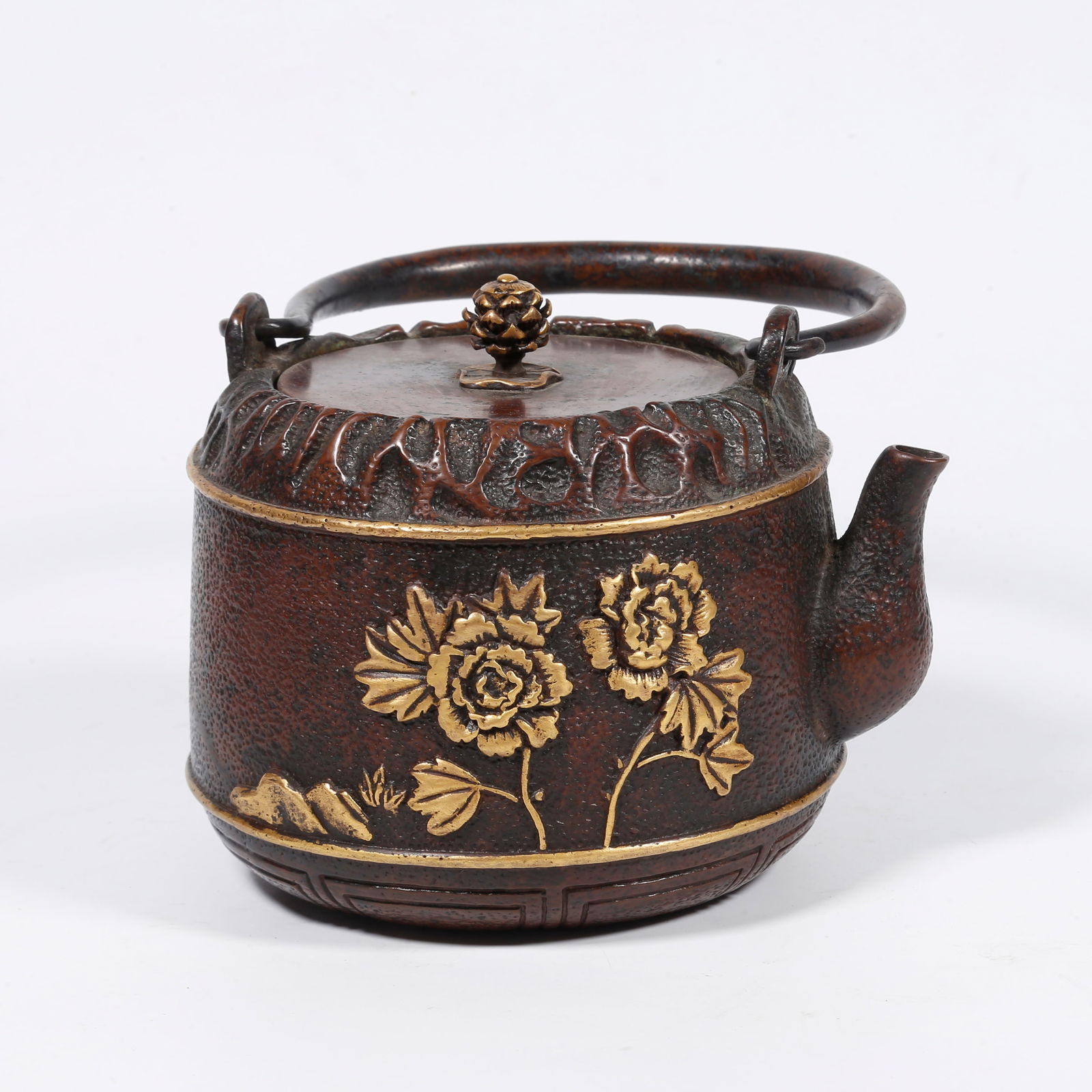A BRONZE TEAPOT WITH FLORAL PATTERN (PARTIALLY GILDED): Bronze teapot with floral pattern (partially gilded)