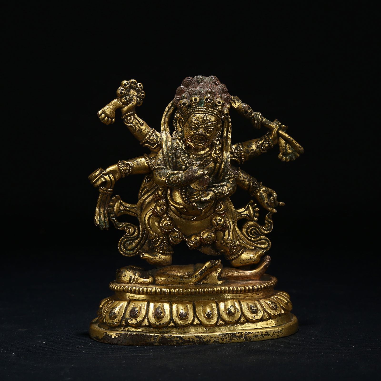 A GILT BRONZE STATUE OF SIX-ARMED MAHAKALA: Gilt bronze statue of Six-Armed Mahakala
