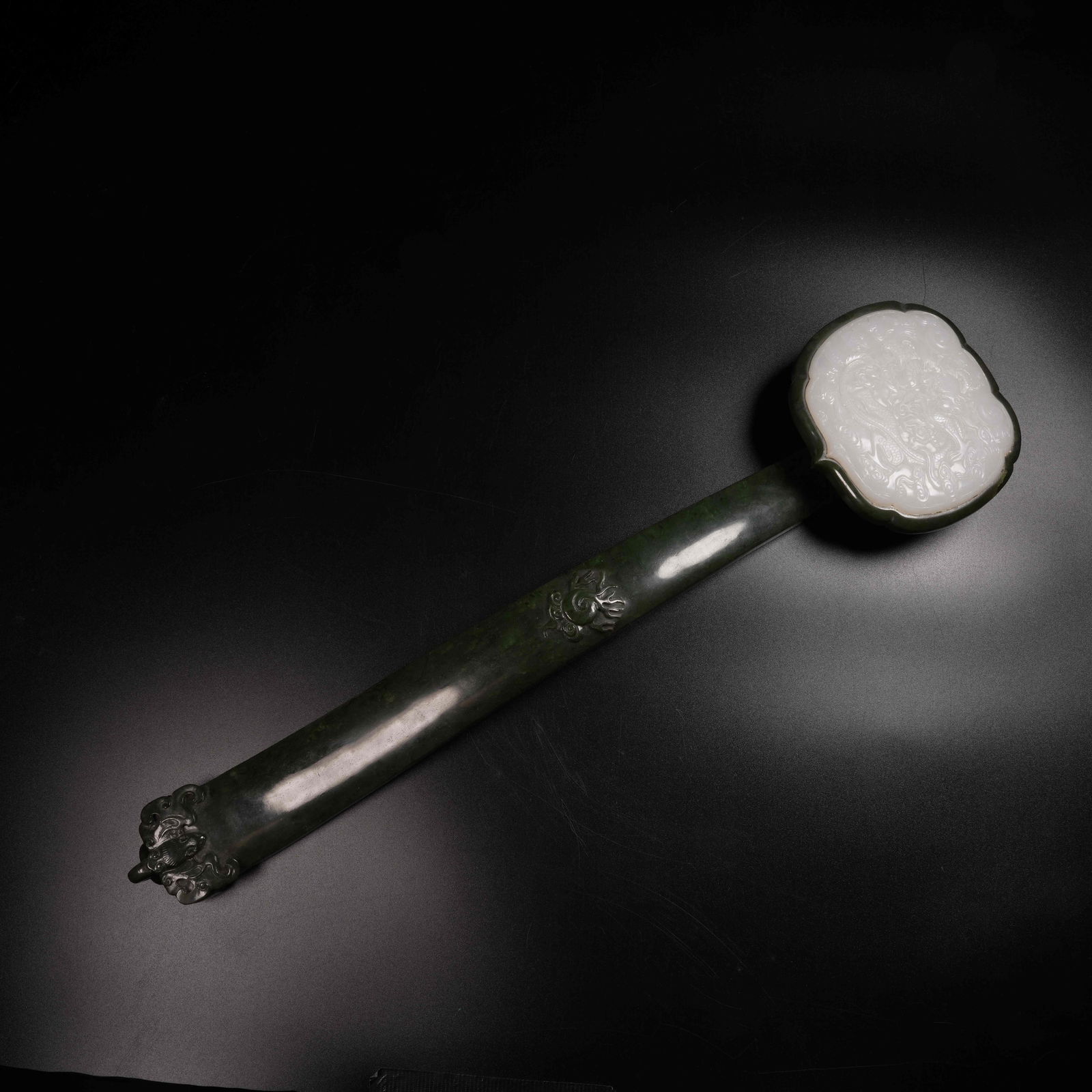 A HETIAN GREEN JADE RUYI INLAID WITH WHITE JADE CLOUD-AND-DRAGON MOTIFS: Hetian green jade Ruyi inlaid with white jade cloud-and-dragon motifs