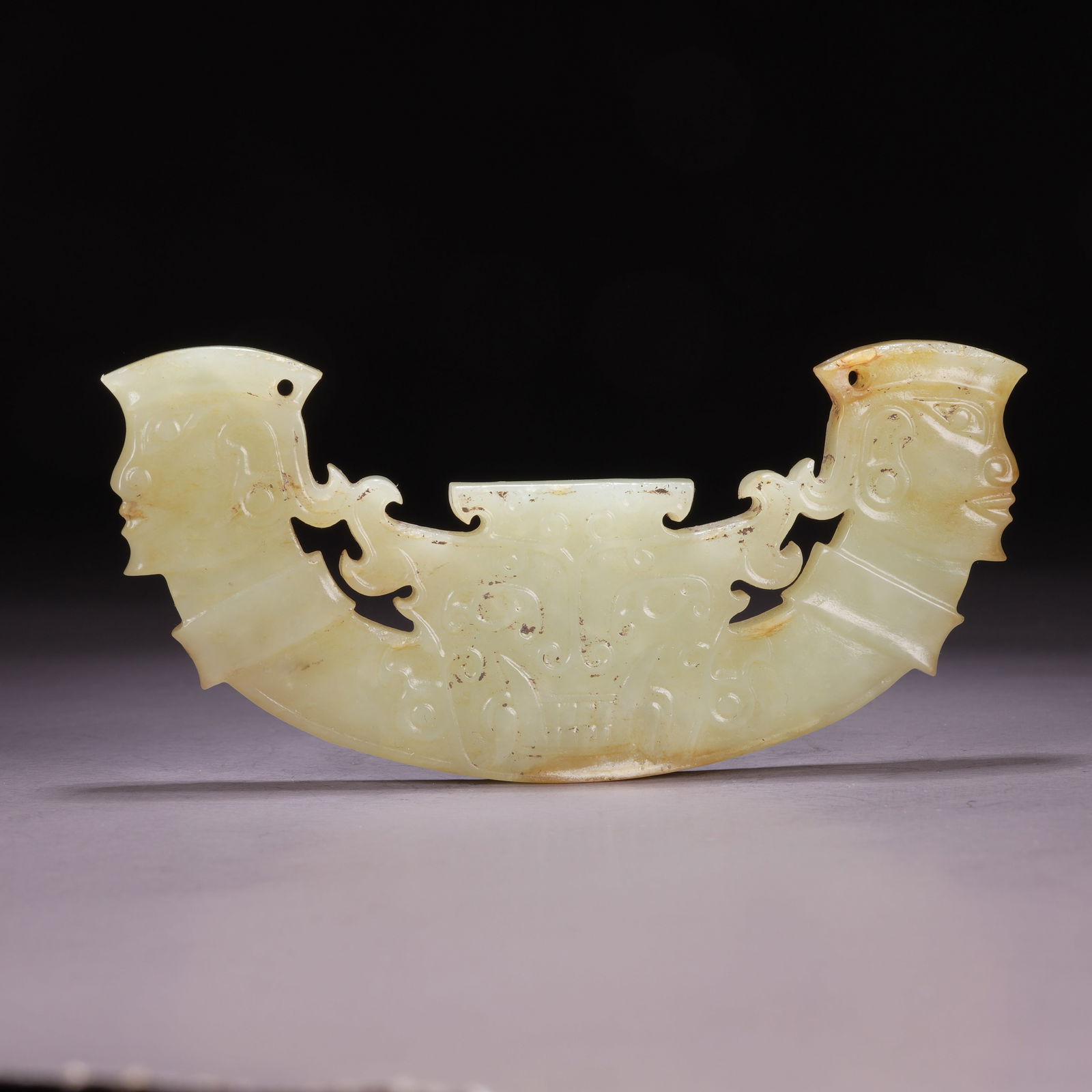 A HIGH-ANTIQUITY JADE DEITY-FACE PENDANT (1 of 9)