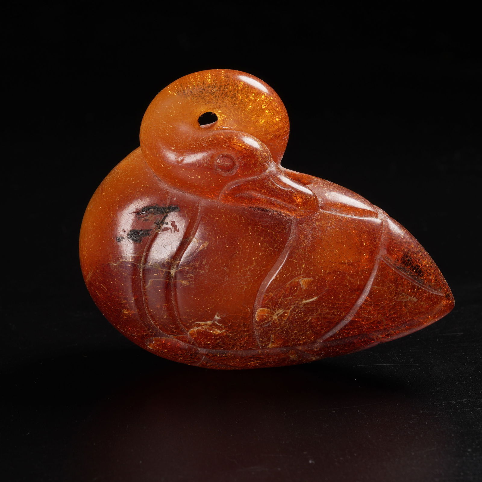 A HONEY-AMBER SNUFF BOTTLE IN THE SHAPE OF A TREASURE DUCK (1 of 8)
