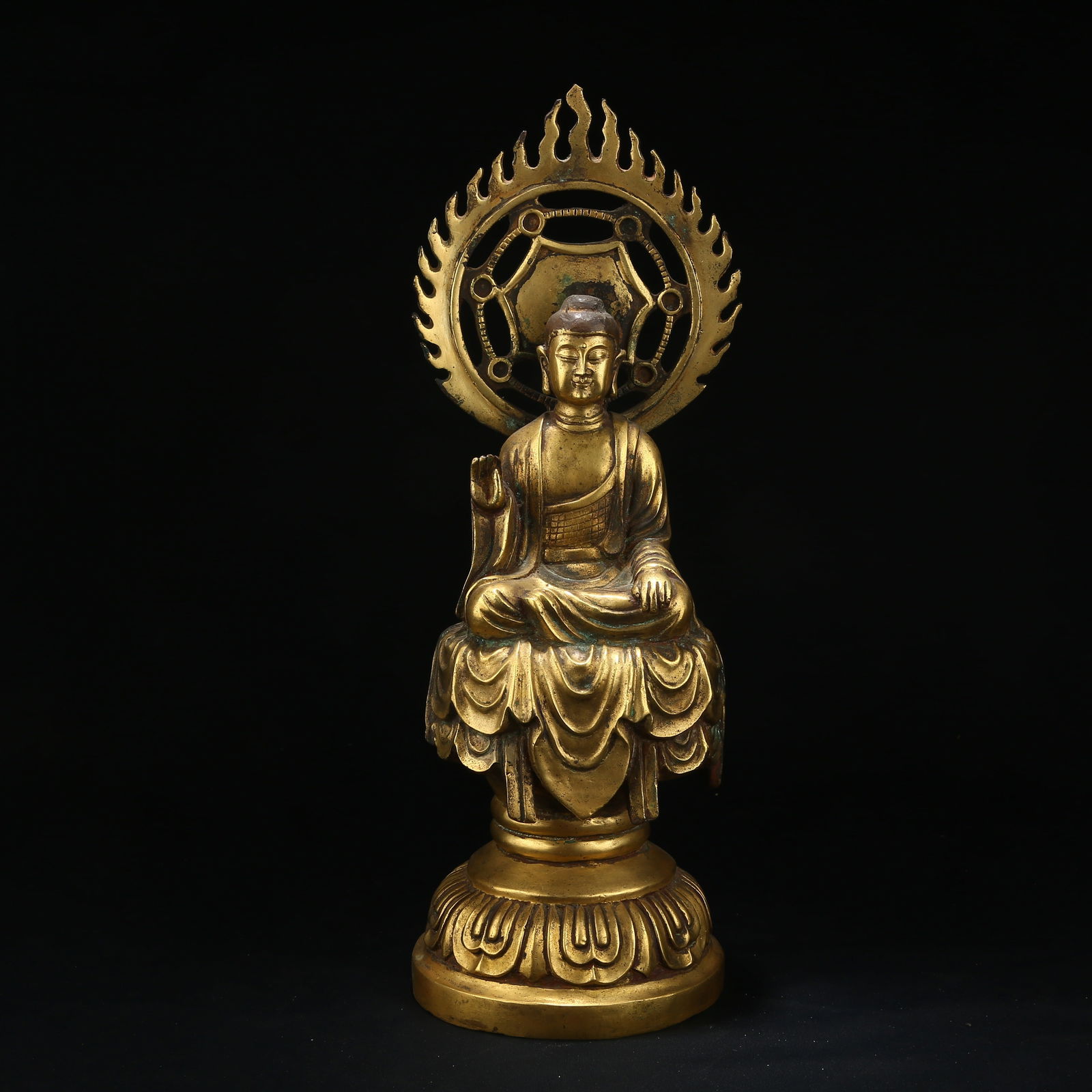 A GILT BRONZE FIGURE OF AMOGHASIDDHI BUDDHA: Gilt Bronze Figure of Amoghasiddhi Buddha