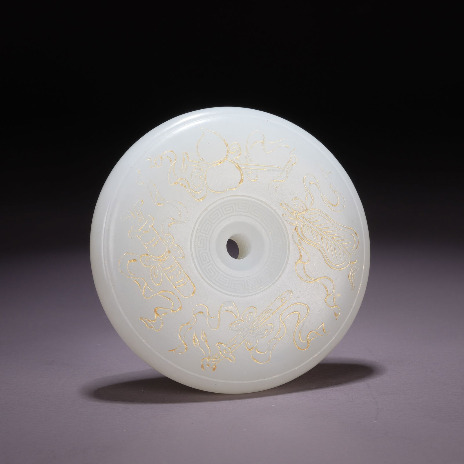 A HETIAN WHITE JADE BI DISC WITH GILT EIGHT AUSPICIOUS EMBLEMS: Hetian White Jade Bi Disc with Gilt Eight Auspicious Emblems
