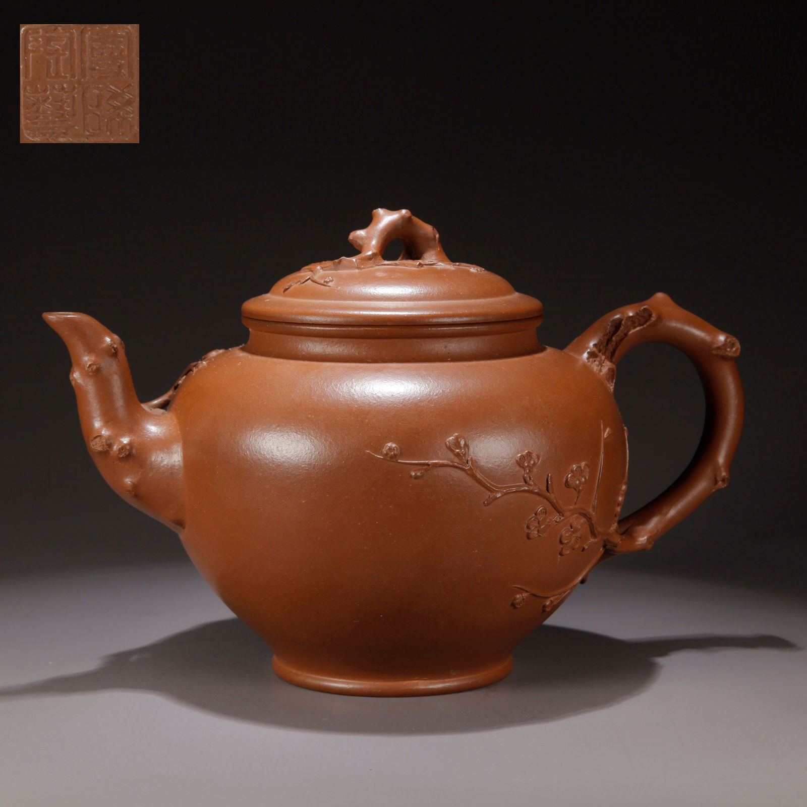A ZISHA CLAY EWER WITH CARVED PLUM BLOSSOM PATTERN: Zisha Clay Ewer with Carved Plum Blossom Pattern