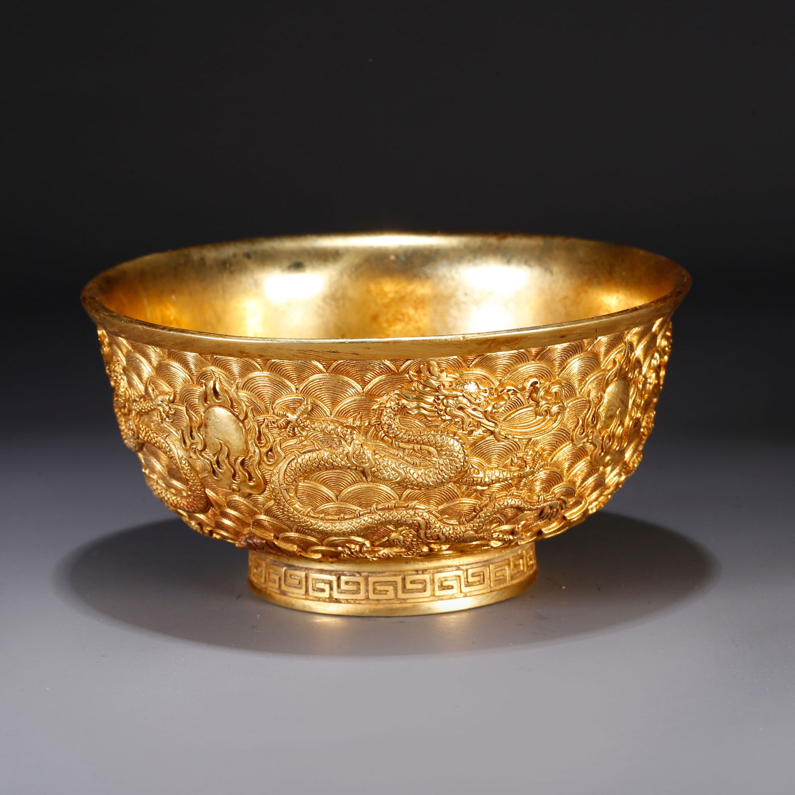 A GILT BRONZE BOWL WITH CLOUD AND DRAGON MOTIF (1 of 9)