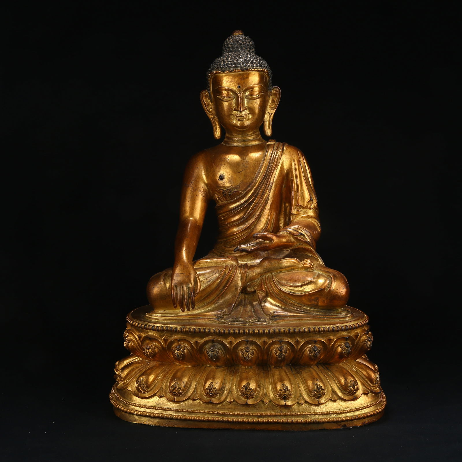 A GILT BRONZE FIGURE OF SHAKYAMUNI BUDDHA: Gilt Bronze Figure of Shakyamuni Buddha
