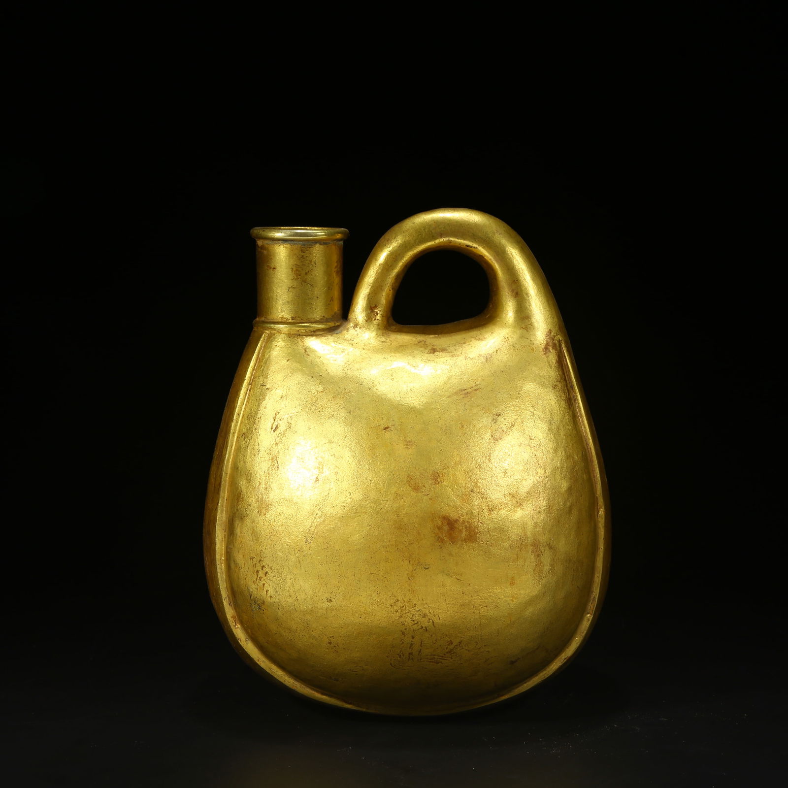 A BRONZE GILT WINESKIN-SHAPED EWER: Bronze gilt wineskin-shaped ewer