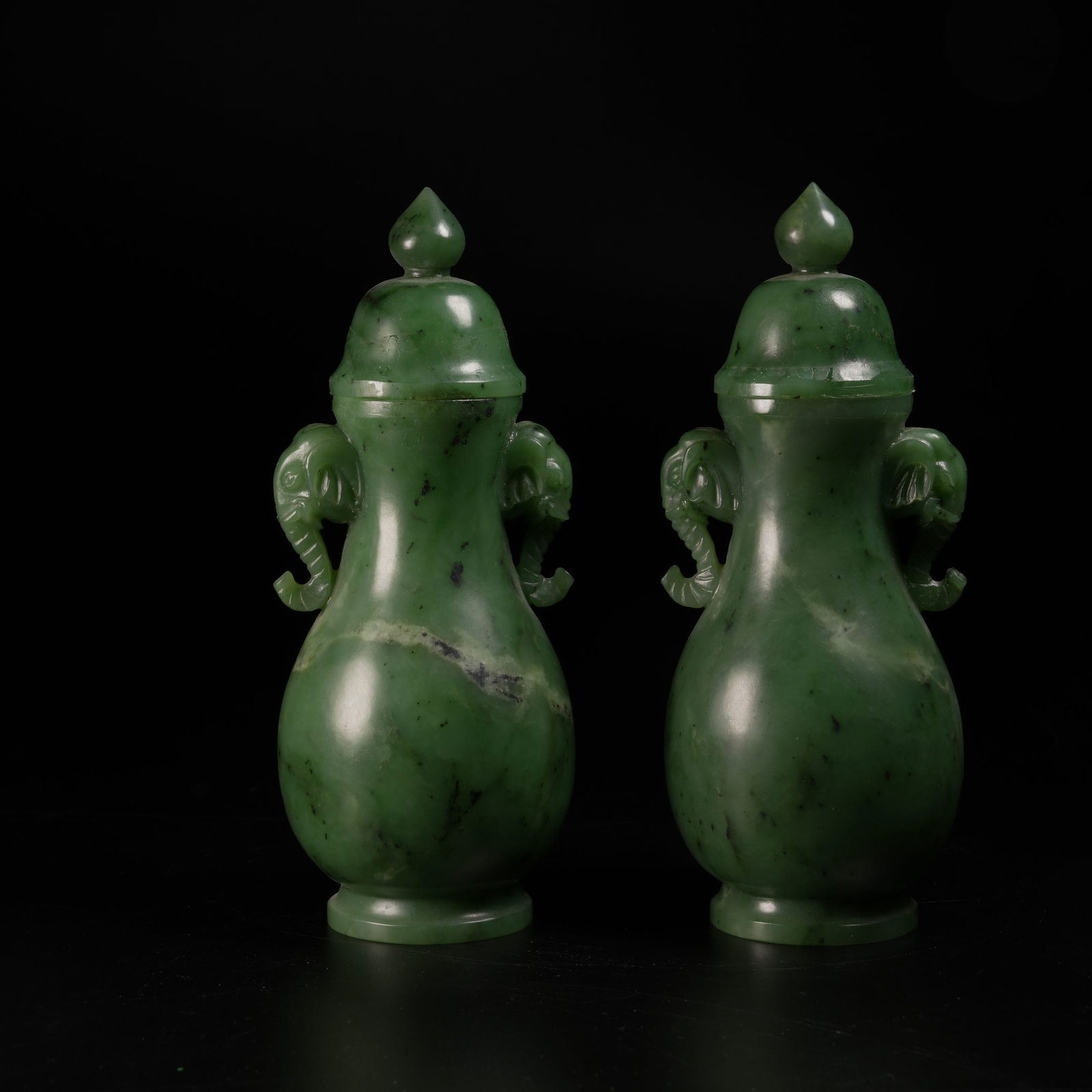 A SET OF HETIAN GREEN JADE ELEPHANT-HAND COVERED VASES: Set of Hetian green jade elephant-hand covered vases