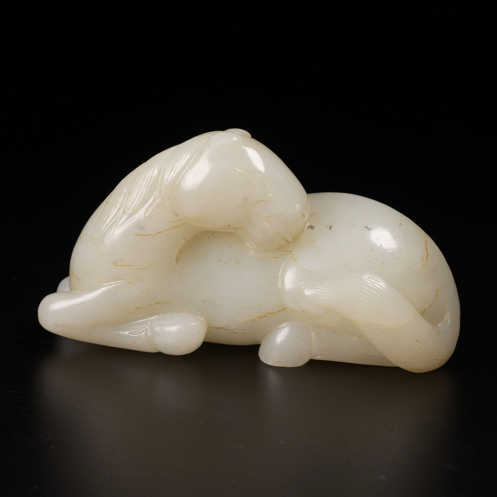 A HETIAN JADE RECUMBENT HORSE FIGURE (1 of 6)