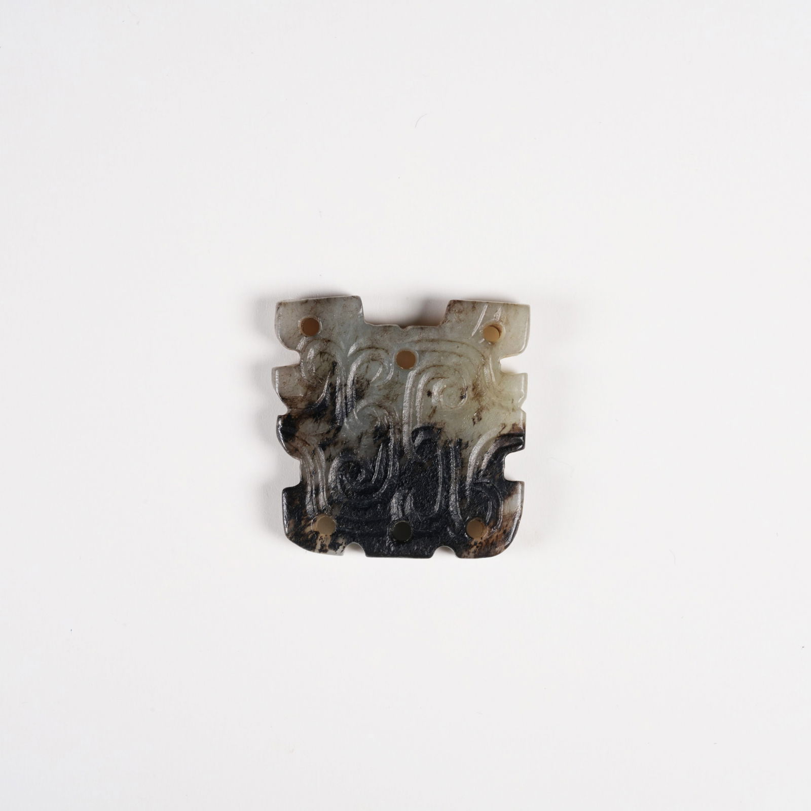 A ARCHAIC JADE PENDANT WITH DEITY FACE MOTIF: Archaic Jade Pendant with Deity Face Motif