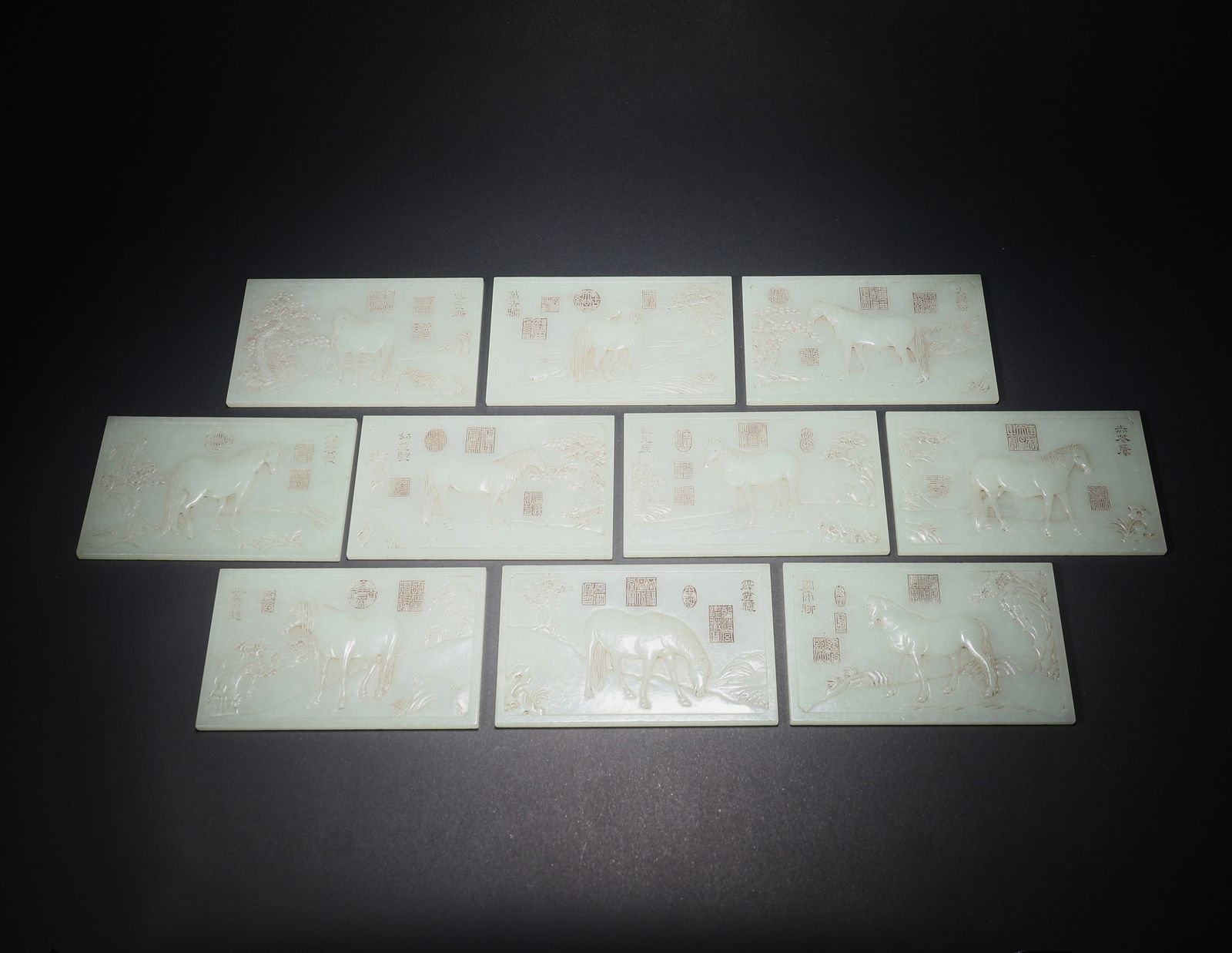 A HETIAN JADE SET OF TEN JADE TABLETS CARVED WITH POETRY AND HORSES: Hetian Jade Set of Ten Jade Tablets Carved with Poetry and Horses