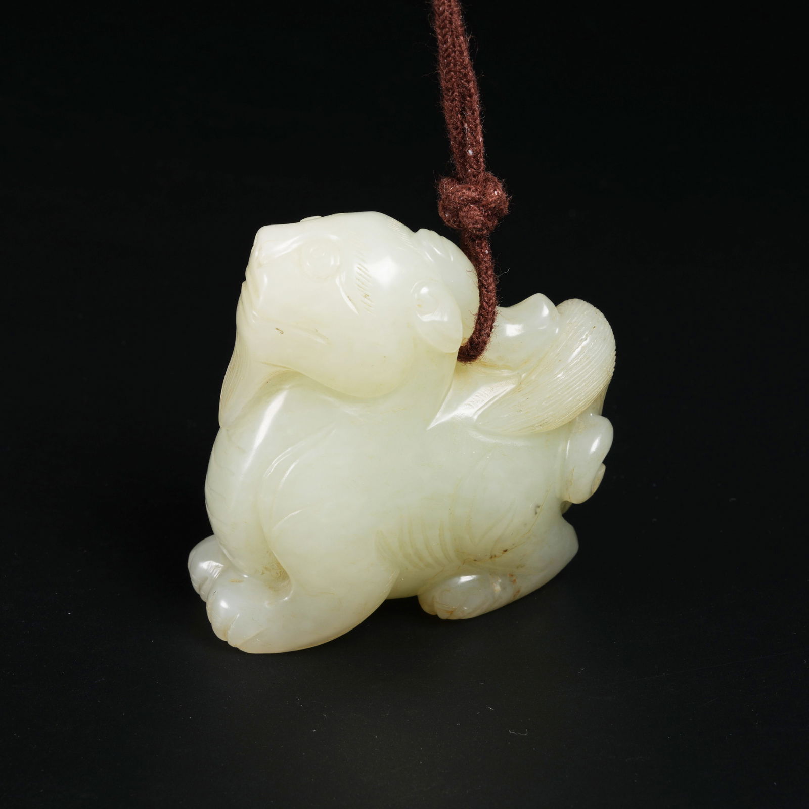 A HETIAN JADE AUSPICIOUS BEAST PENDANT (1 of 8)