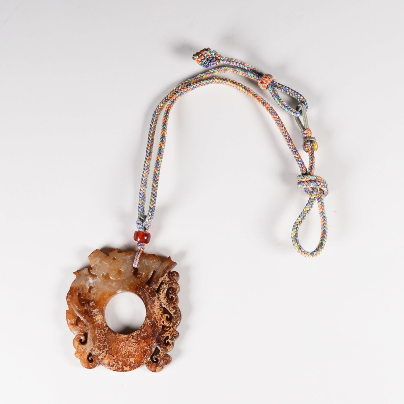 A ARCHAIC JADE CHICKEN-HEART PENDANT WITH DRAGON MOTIF: Archaic Jade Chicken-Heart Pendant with Dragon Motif