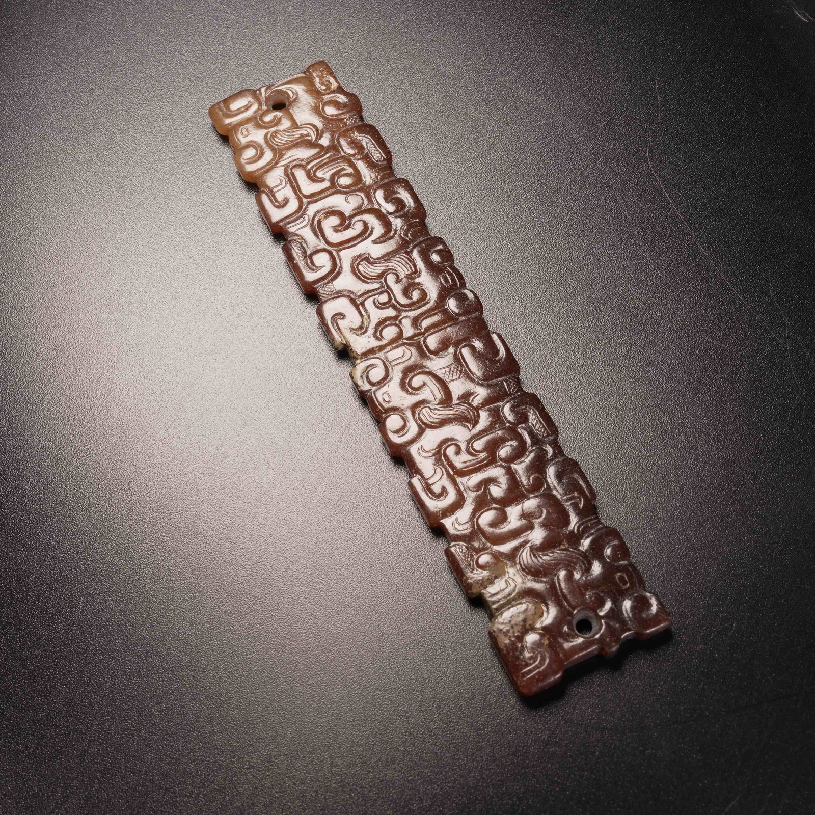 A ANCIENT JADE PENDANT WITH CLOUD-HOOK MOTIF: Ancient jade pendant with cloud-hook motif