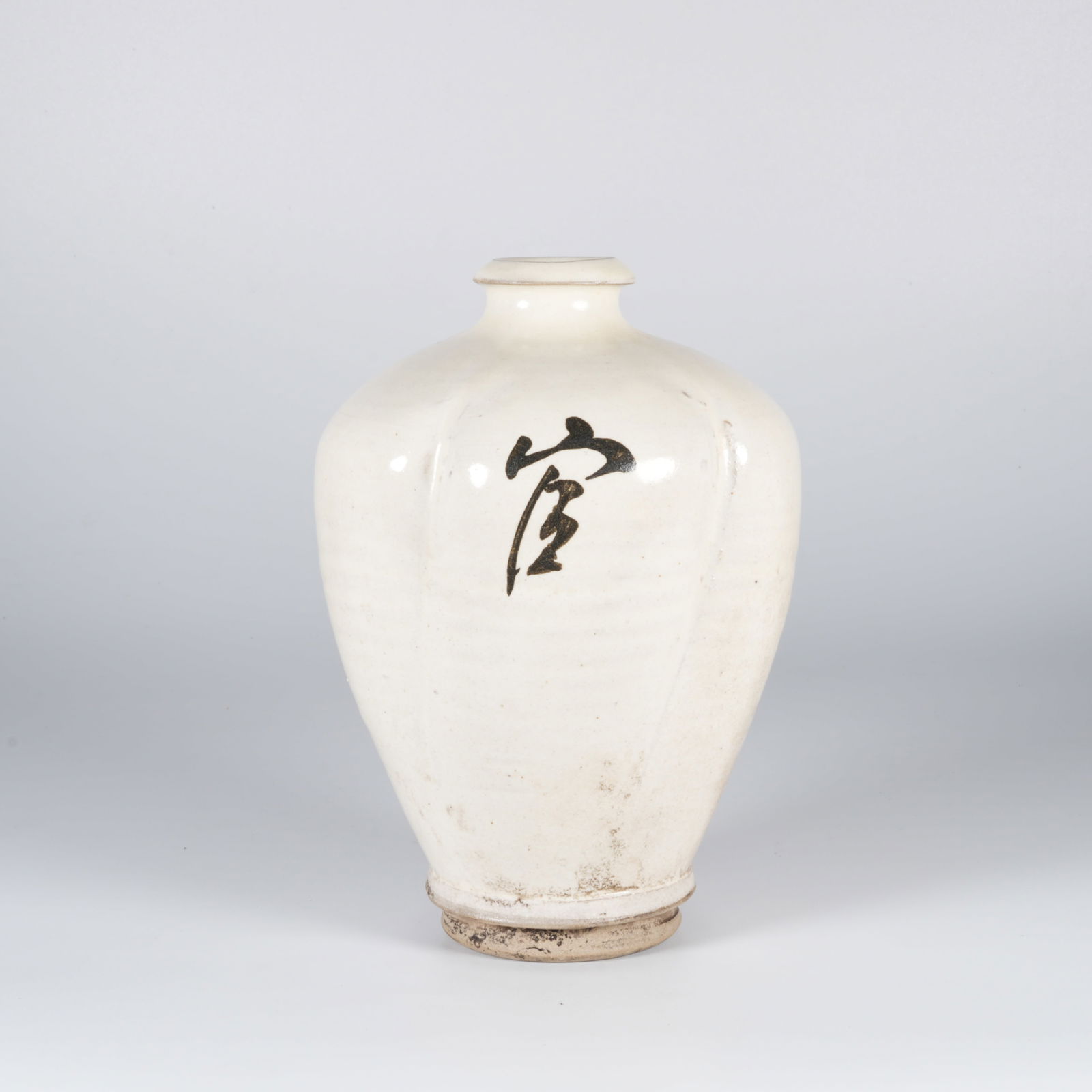 A WHITE-GLAZED MELON-RIBBED JAR: White-glazed melon-ribbed jar