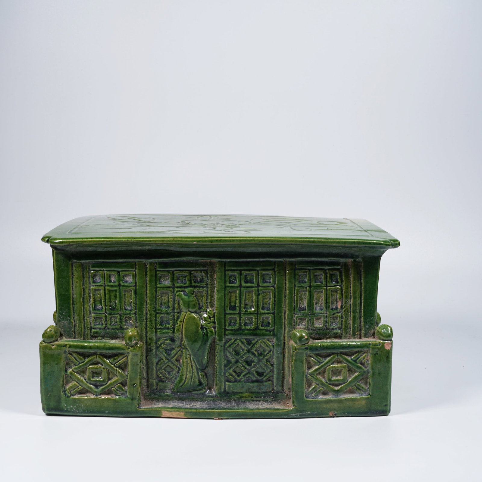 A GREEN-GLAZED PORCELAIN PILLOW: Green-glazed porcelain pillow