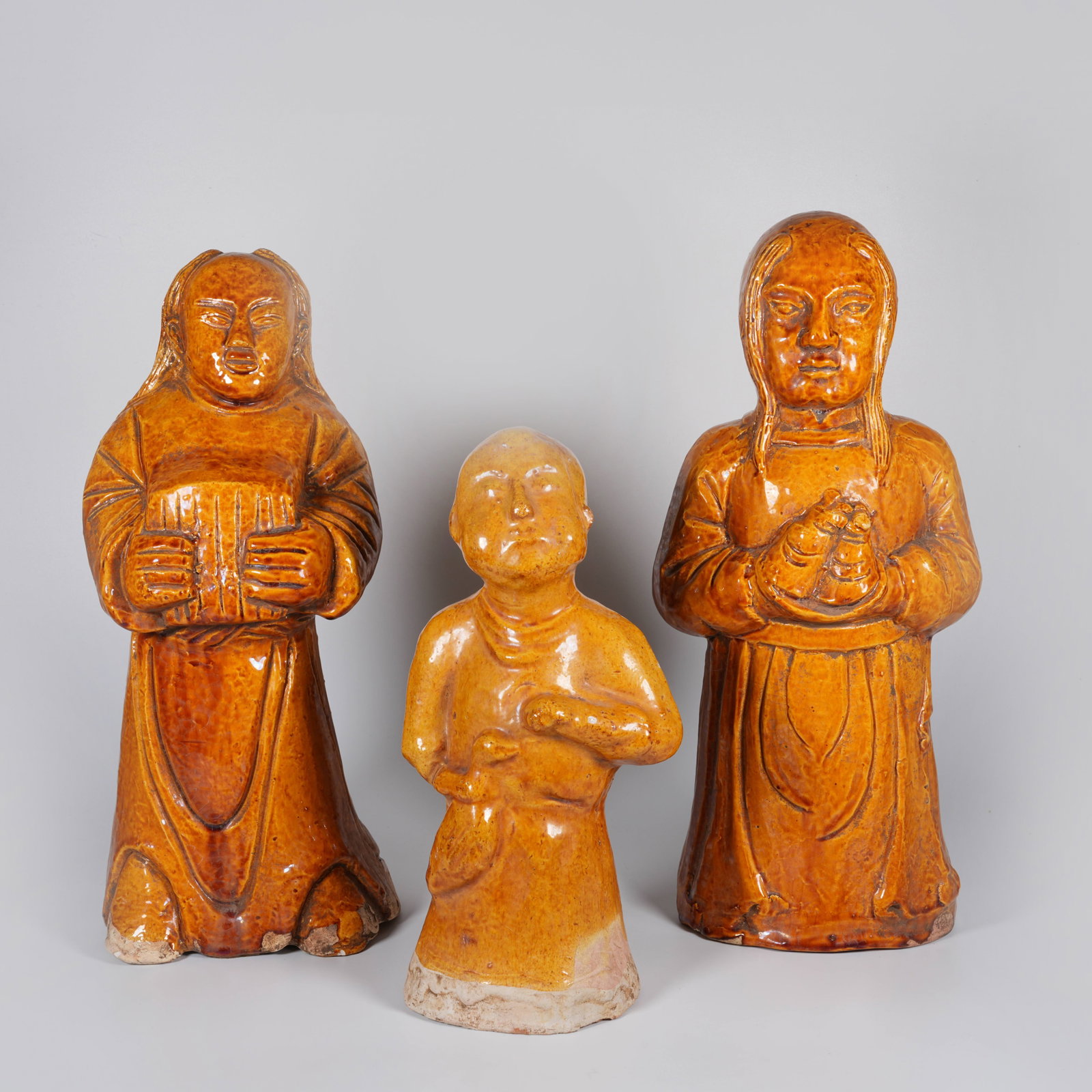 A SET OF YELLOW-GLAZED FIGURINES: Set of yellow-glazed figurines