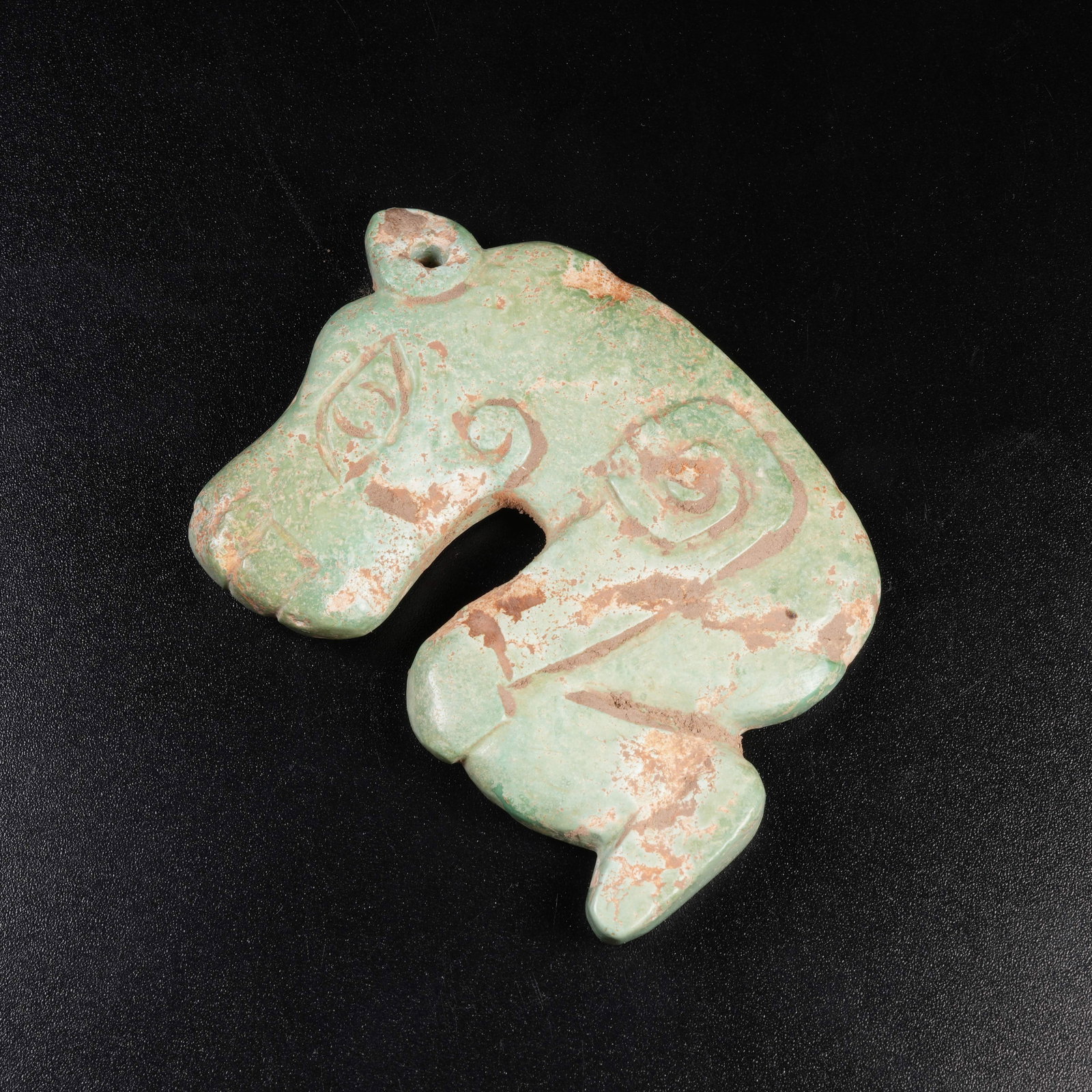 A TURQUOISE BEAST-AND-HUMAN PENDANT: Turquoise beast-and-human pendant