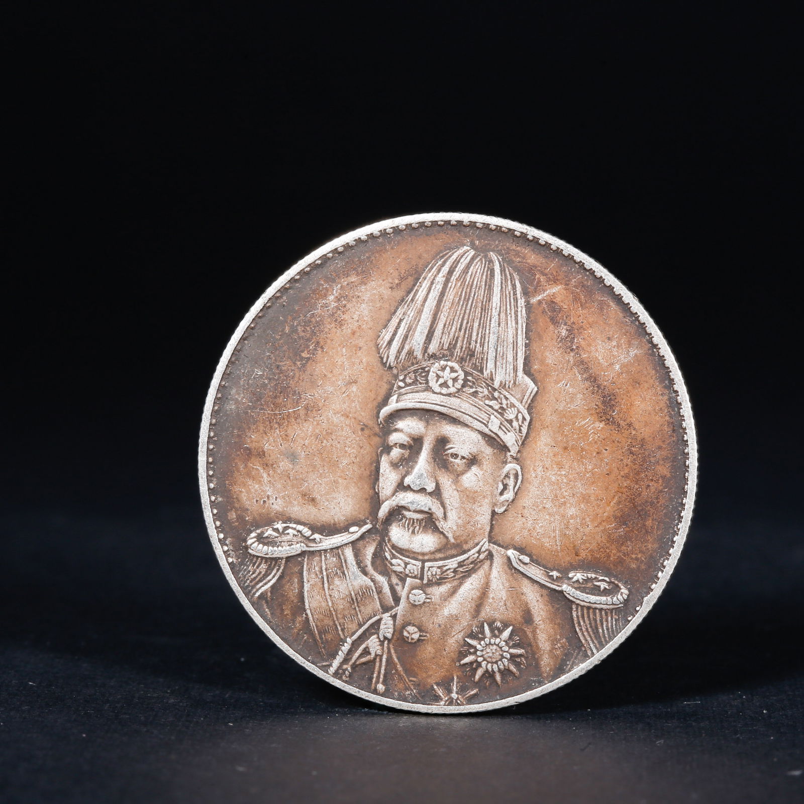 A SILVER DOLLAR COIN: One Silver dollar Coin