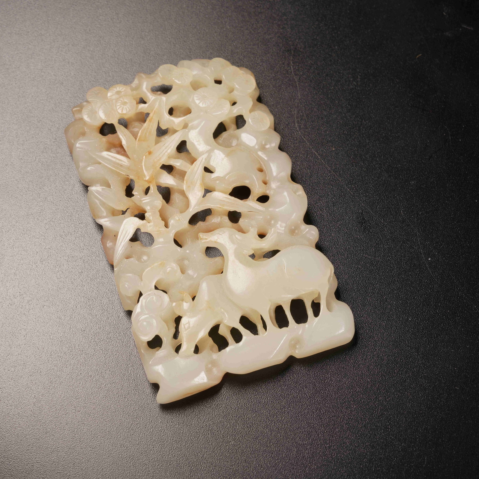 A HETIAN JADE BELT ORNAMENT WITH AUTUMN-MOUNTAIN MOTIF: Hetian jade belt ornament with autumn-mountain motif