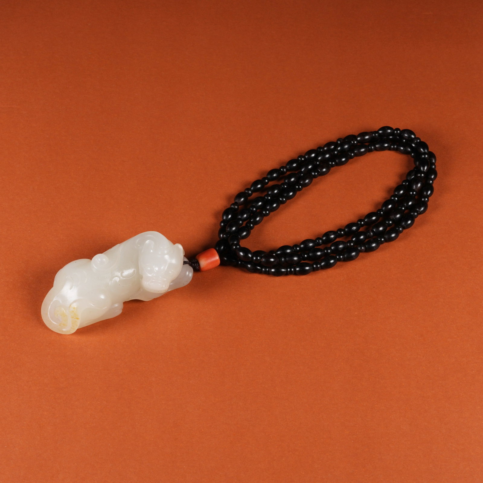 A HETIAN JADE AUSPICIOUS BEAST PENDANT (1 of 9)