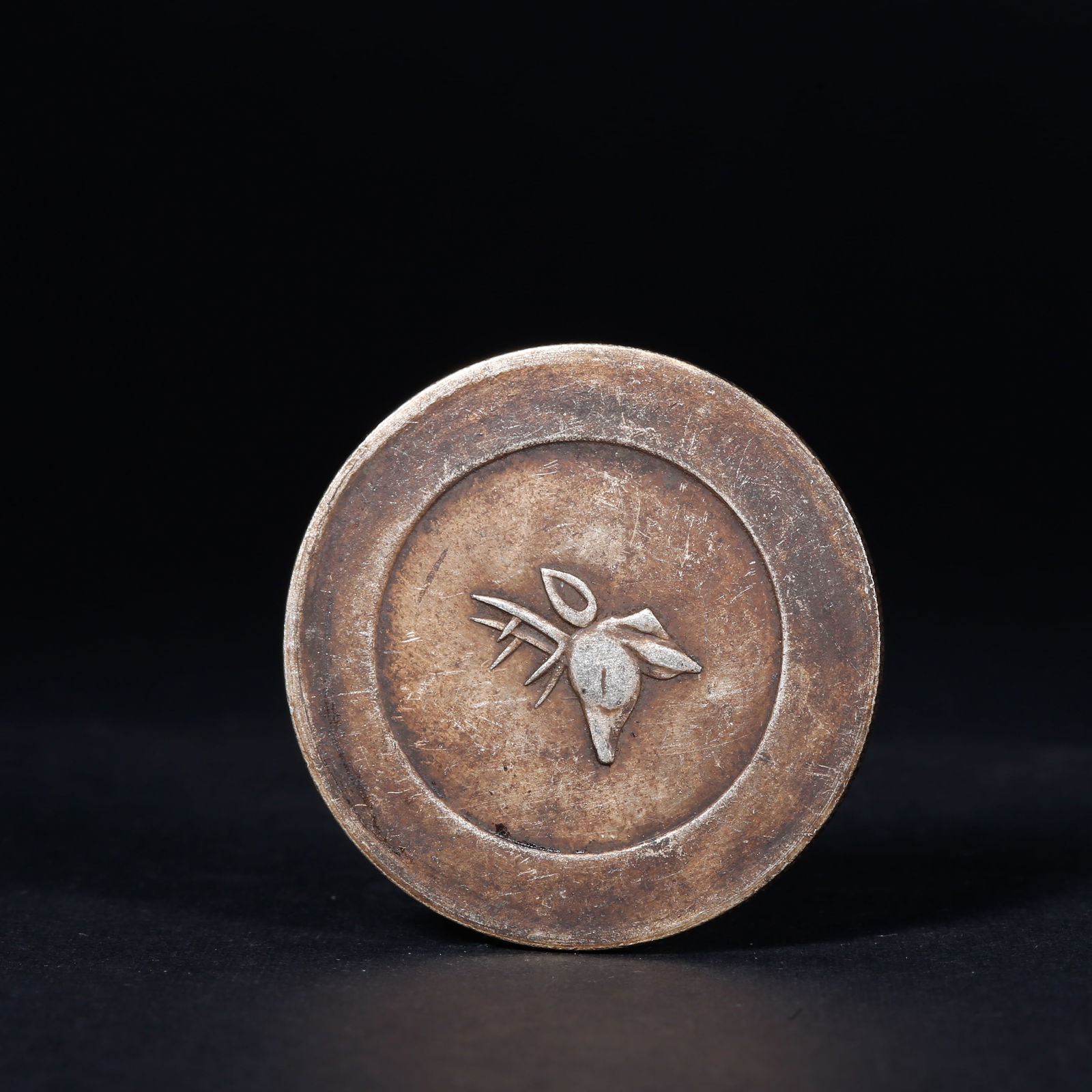 A SILVER DOLLAR COIN: One Silver dollar Coin