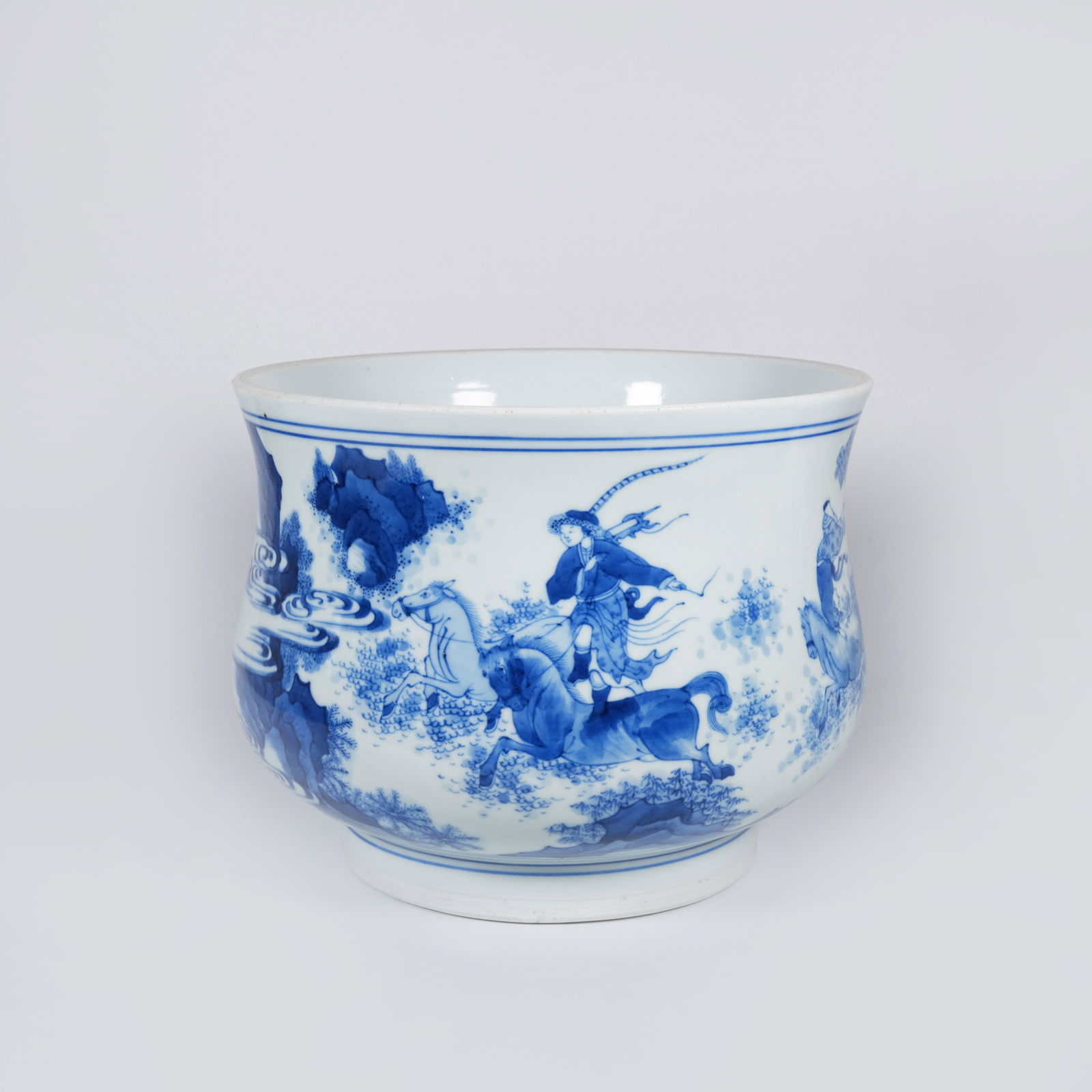 A BLUE-AND-WHITE INCENSE BURNER WITH HORSE-AND-RIDER MOTIF: Blue-and-white incense burner with horse-and-rider motif