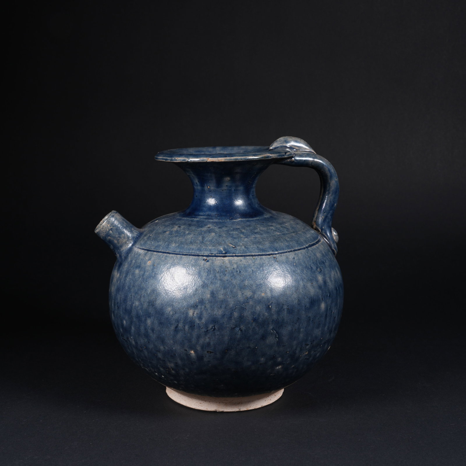 A HANGING-BLUE GLAZED EWER: Hanging-blue glazed ewer