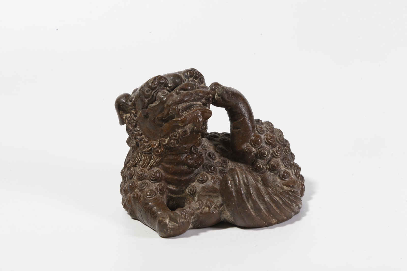 A BRONZE LION-SHAPED FIGURINE: Bronze Lion-Shaped Figurine