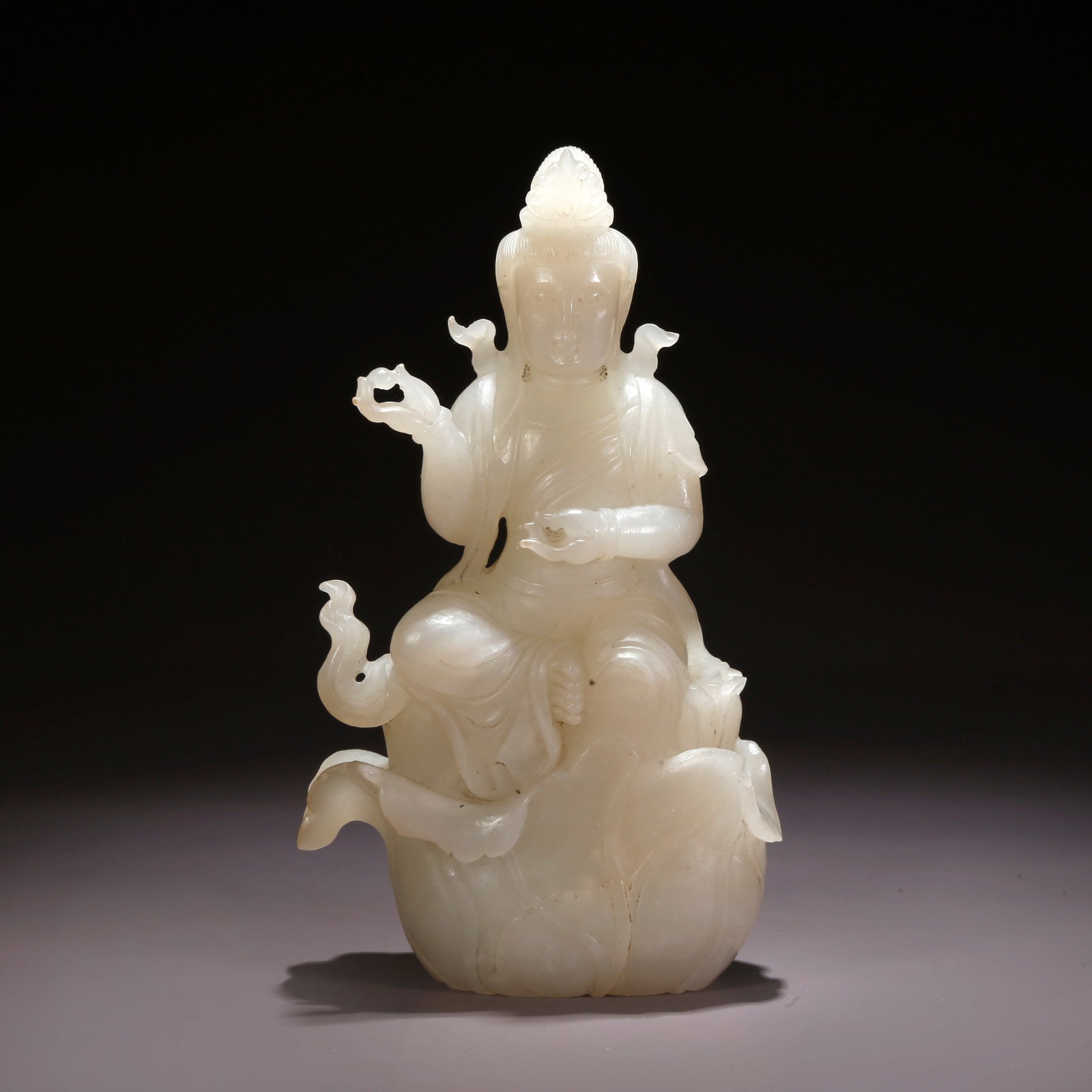 A HETIAN JADE BUDDHA FIGURE (1 of 9)