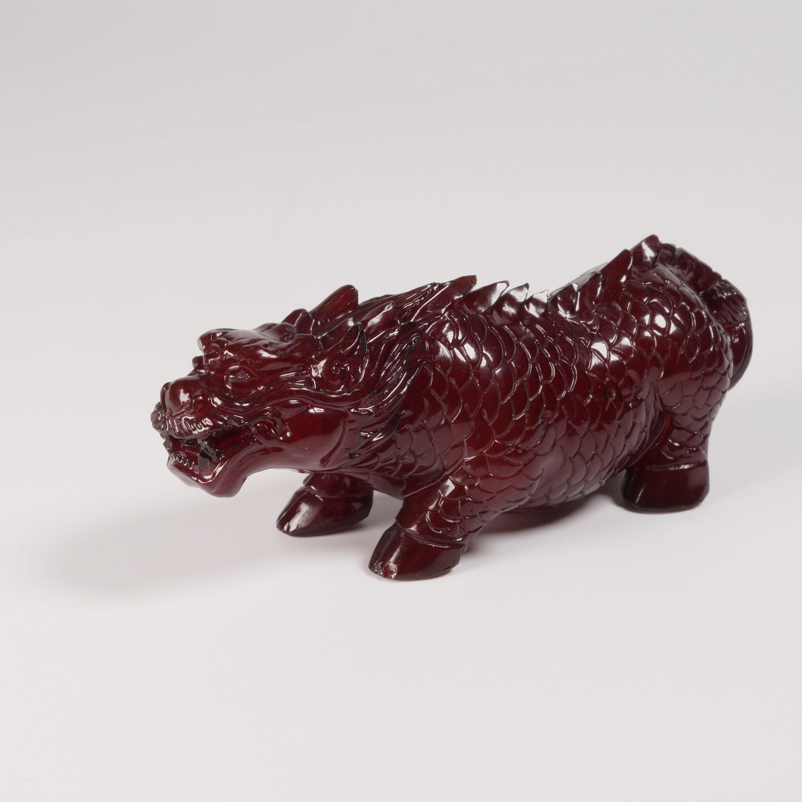 A HONEY-AMBER AUSPICIOUS BEAST FIGURE (1 of 8)