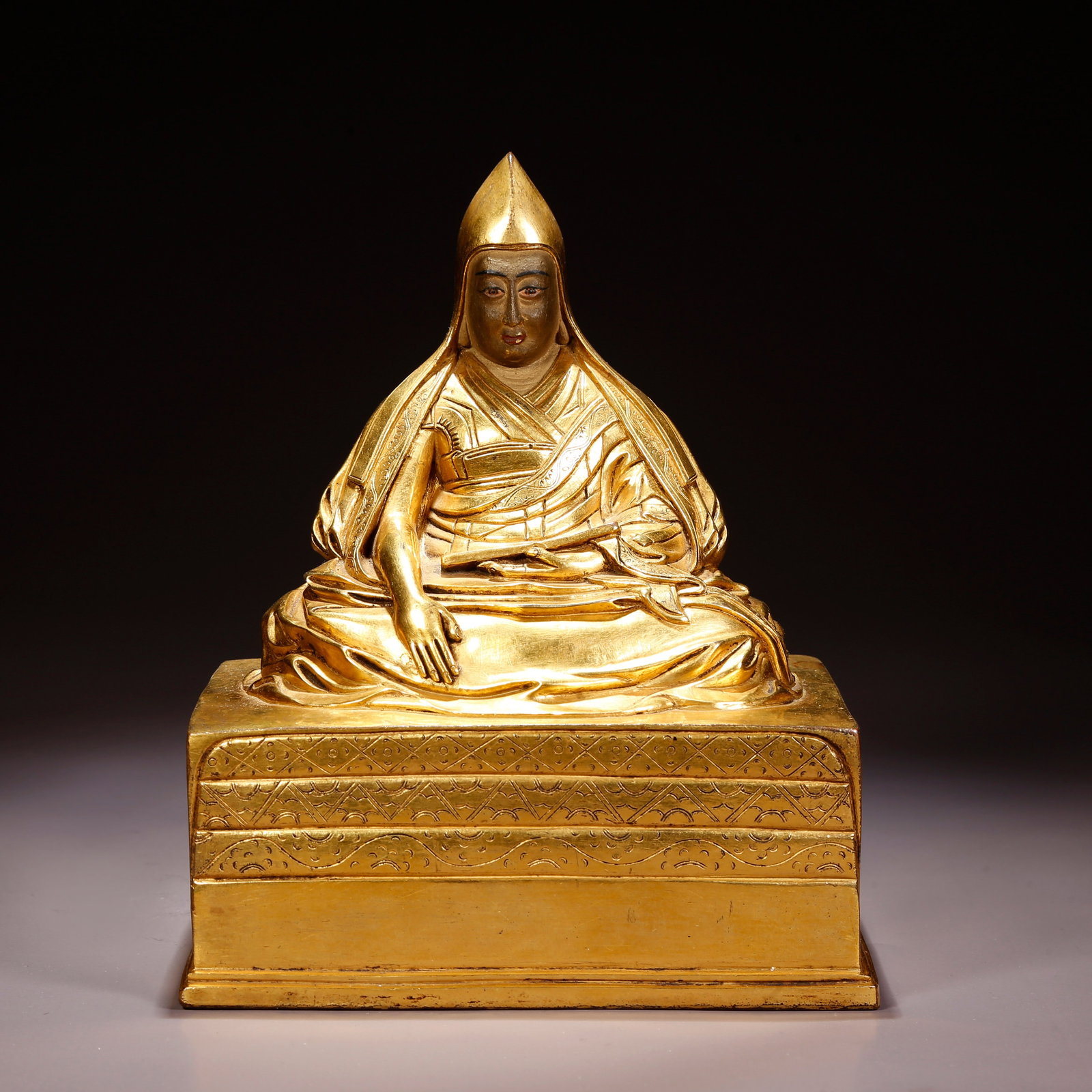 A GILT-BRONZE LAMA FIGURE (1 of 9)