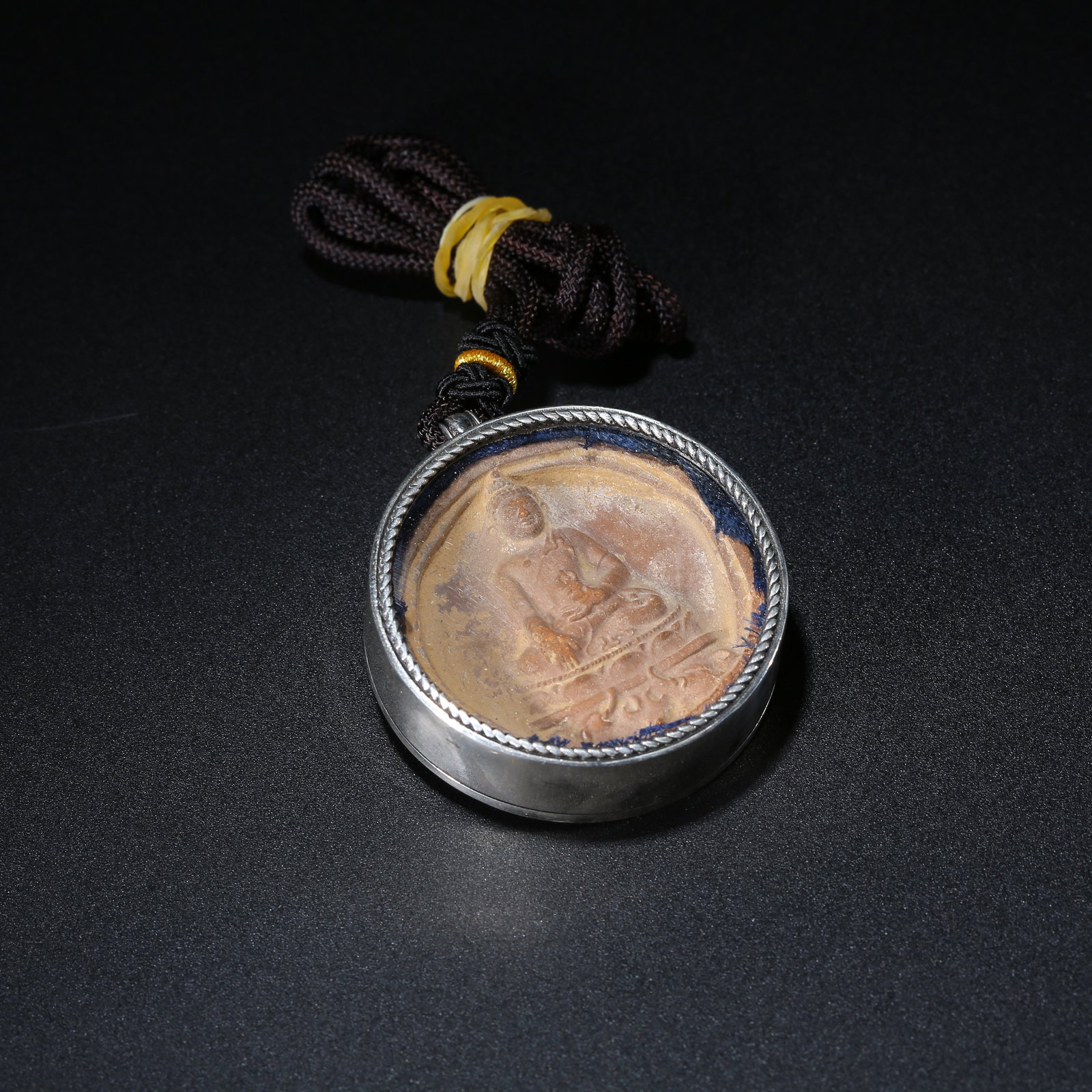 A CLAY SHAKYAMUNI TSA-TSA WITH SILVER GAWU BOX: Clay Shakyamuni Tsa-Tsa with Silver Gawu Box