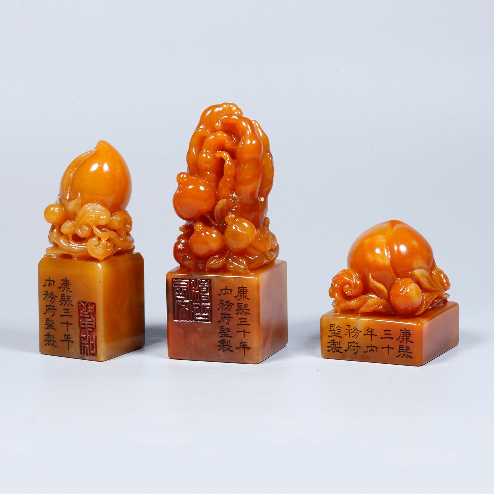 A SET OF SHOUSHAN TIANHUANG STONE CARVED SEALS WITH FU, LU, SHOU FIGURE FINIALS (1 of 9)