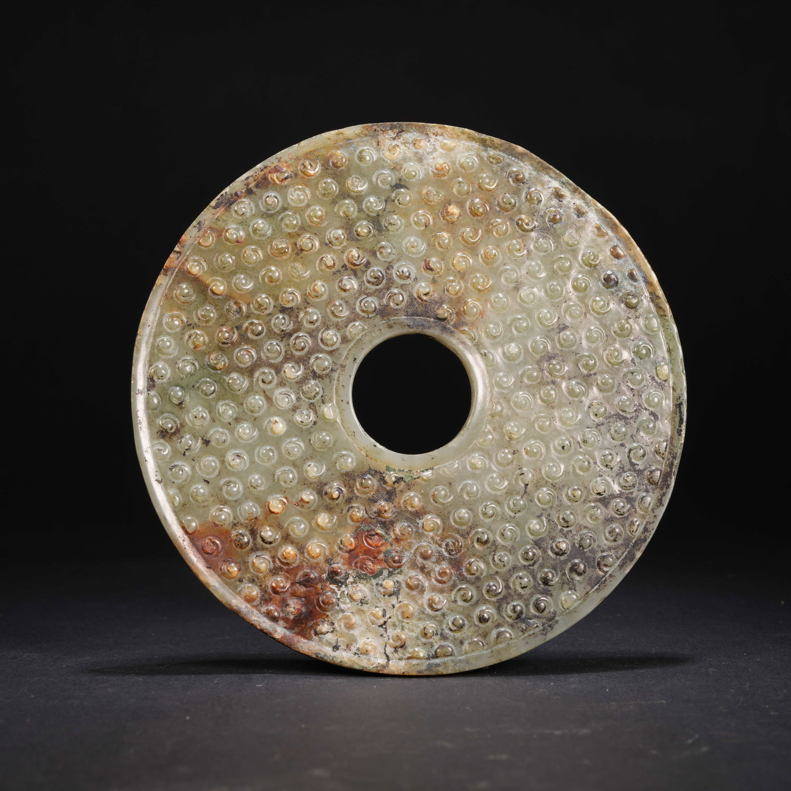 A ANCIENT JADE BI DISK WITH HOOKED CLOUD MOTIF (1 of 9)