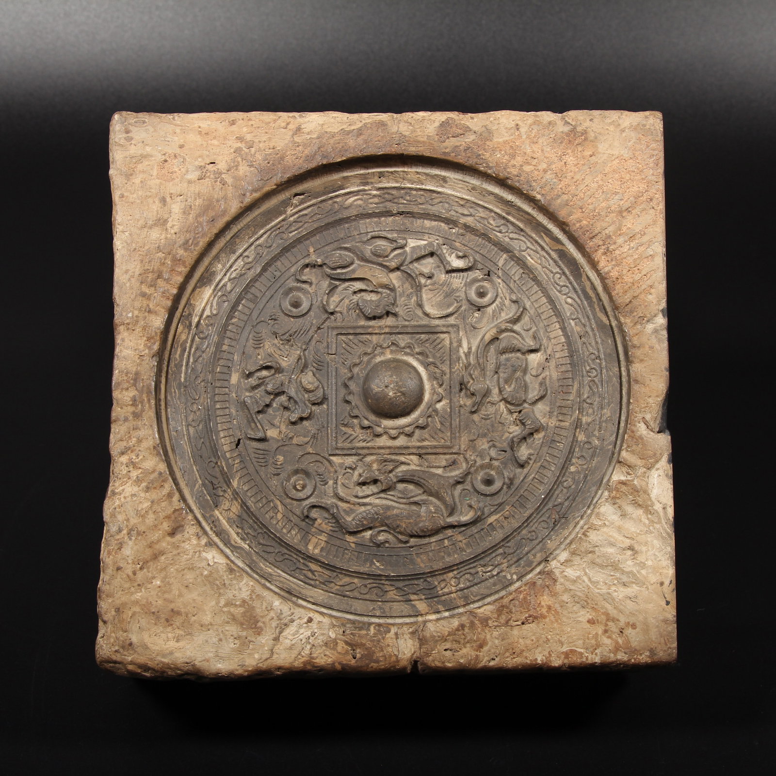 A STONE-CARVED BRICK WITH AUSPICIOUS BEAST AND BRONZE MIRROR MOTIF (1 of 13)