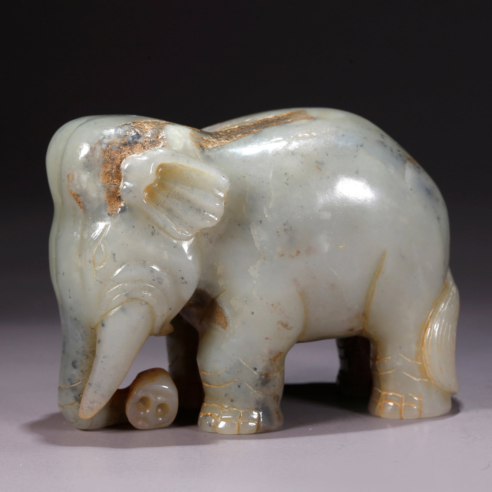 A HETIAN JADE "PEACE AND PROSPERITY" ELEPHANT-SHAPED FIGURINE (1 of 10)