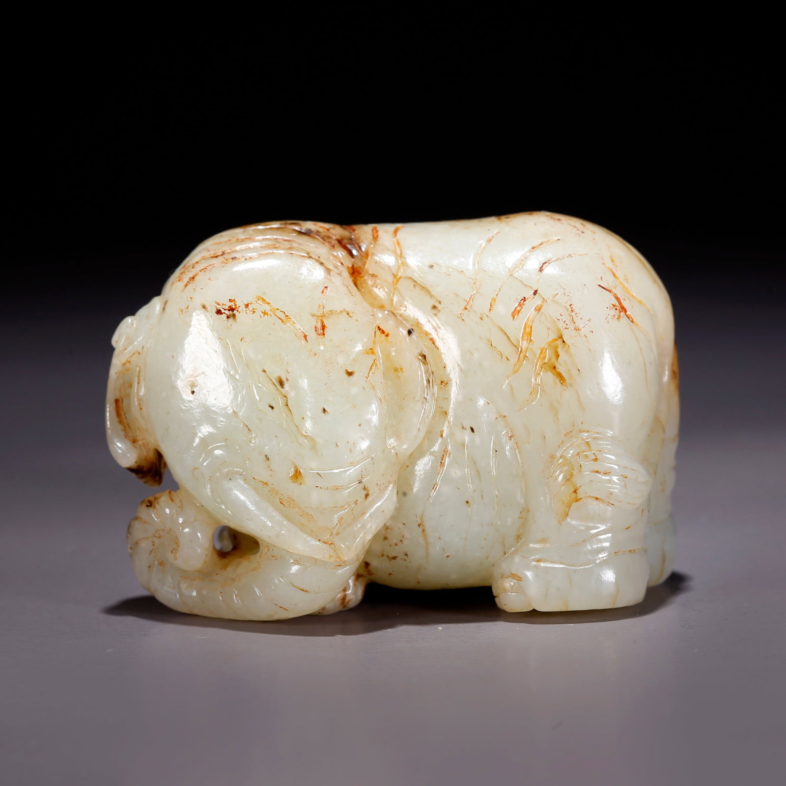 A HETIAN JADE "PEACE AND PROSPERITY" ELEPHANT-SHAPED FIGURINE (1 of 9)