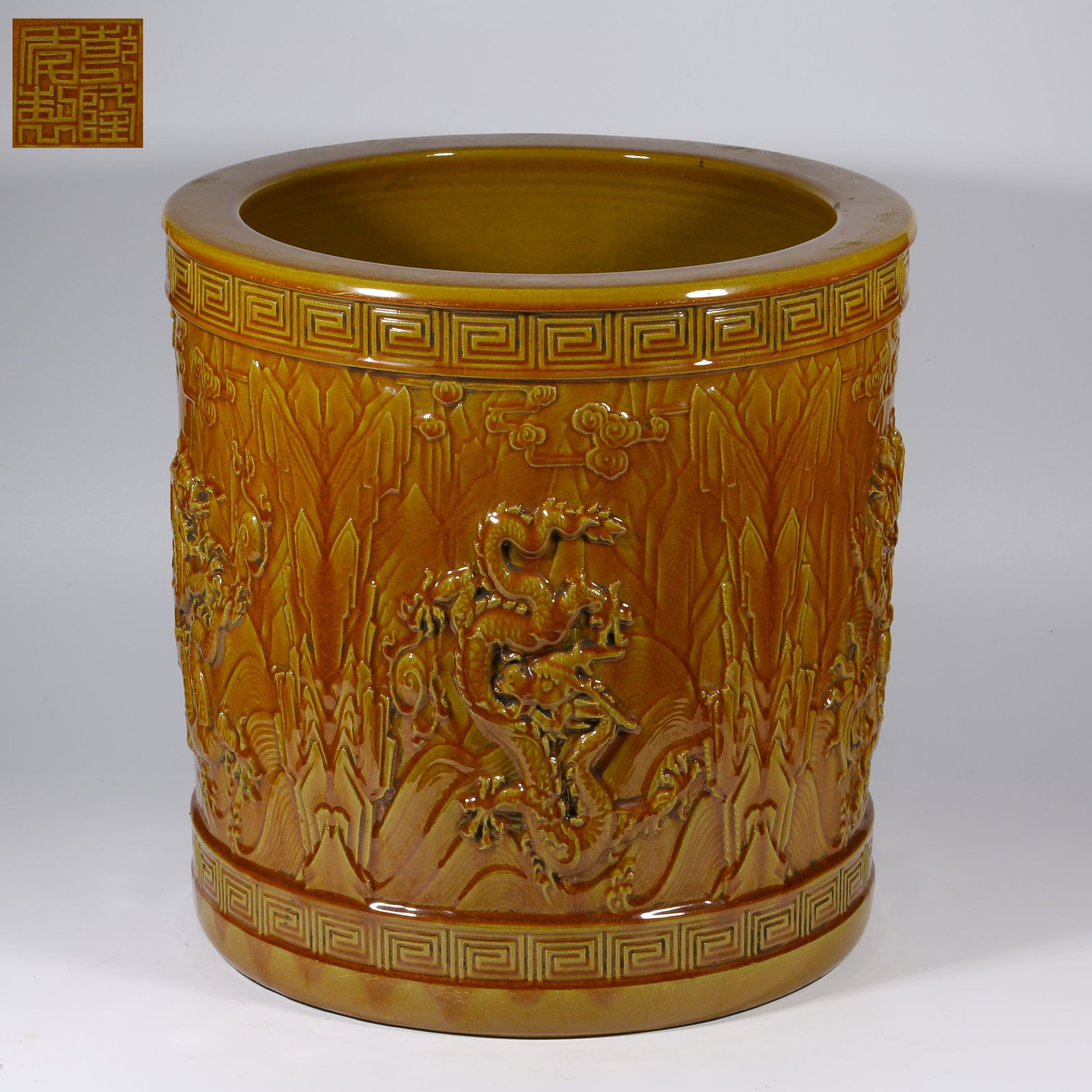 A YELLOW-GLAZED HIGH-RELIEF BRUSH HOLDER WITH JIANGYA SEA-DRAGON MOTIF: Yellow-Glazed High-Relief Brush Holder with Jiangya Sea-Dragon Motif