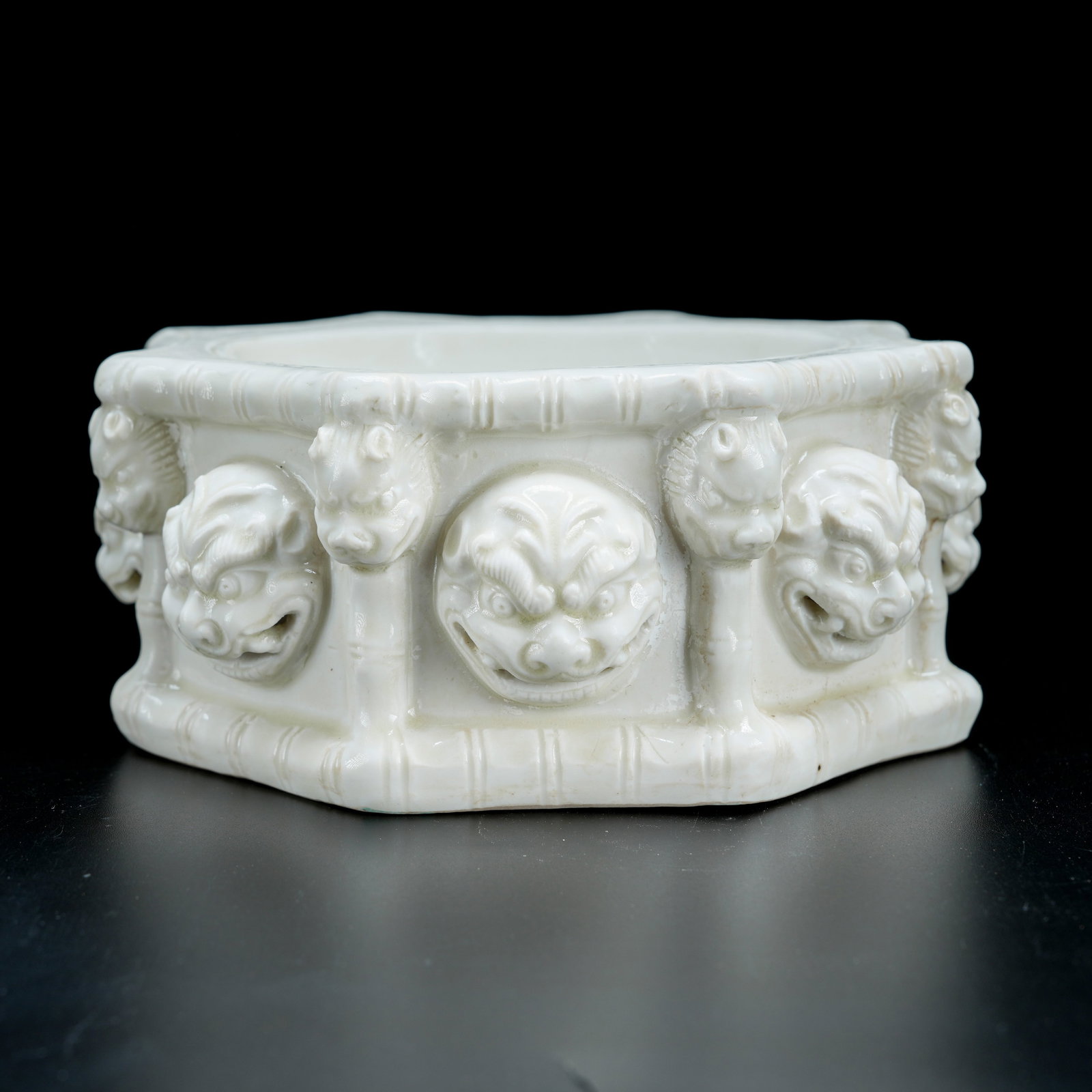 A WHITE PORCELAIN AUSPICIOUS LION HEAD BASE (1 of 9)