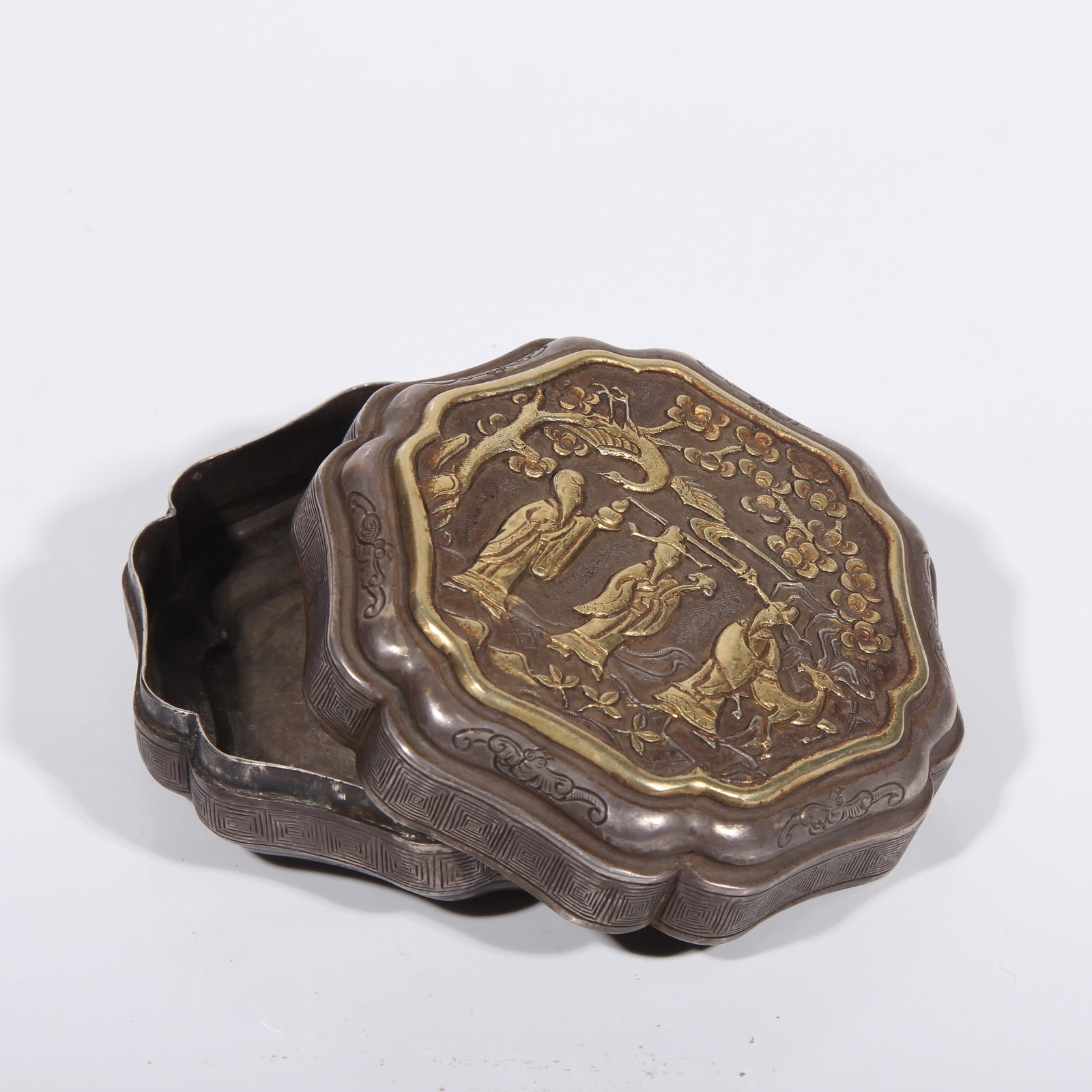 A SILVER COVERED BOX WITH PARTIAL GILDING, FEATURING FORTUNE, PROSPERITY, AND LONGEVITY MOTIF: Silver Covered Box with Partial Gilding, Featuring Fortune, Prosperity, and Longevity Motif