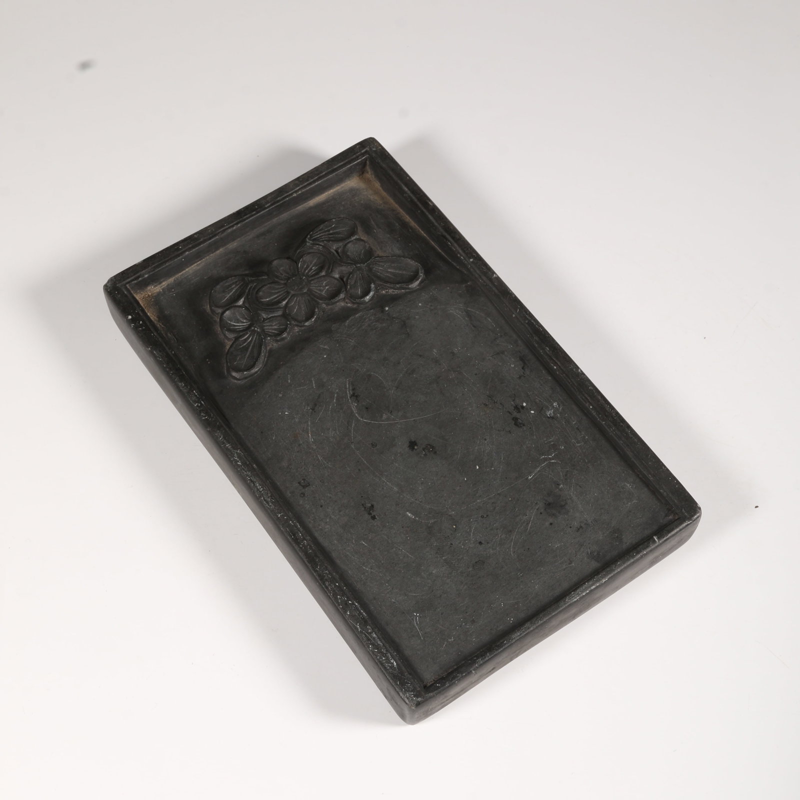 A SHE INKSTONE WITH FLORAL MOTIF: She Inkstone with Floral Motif