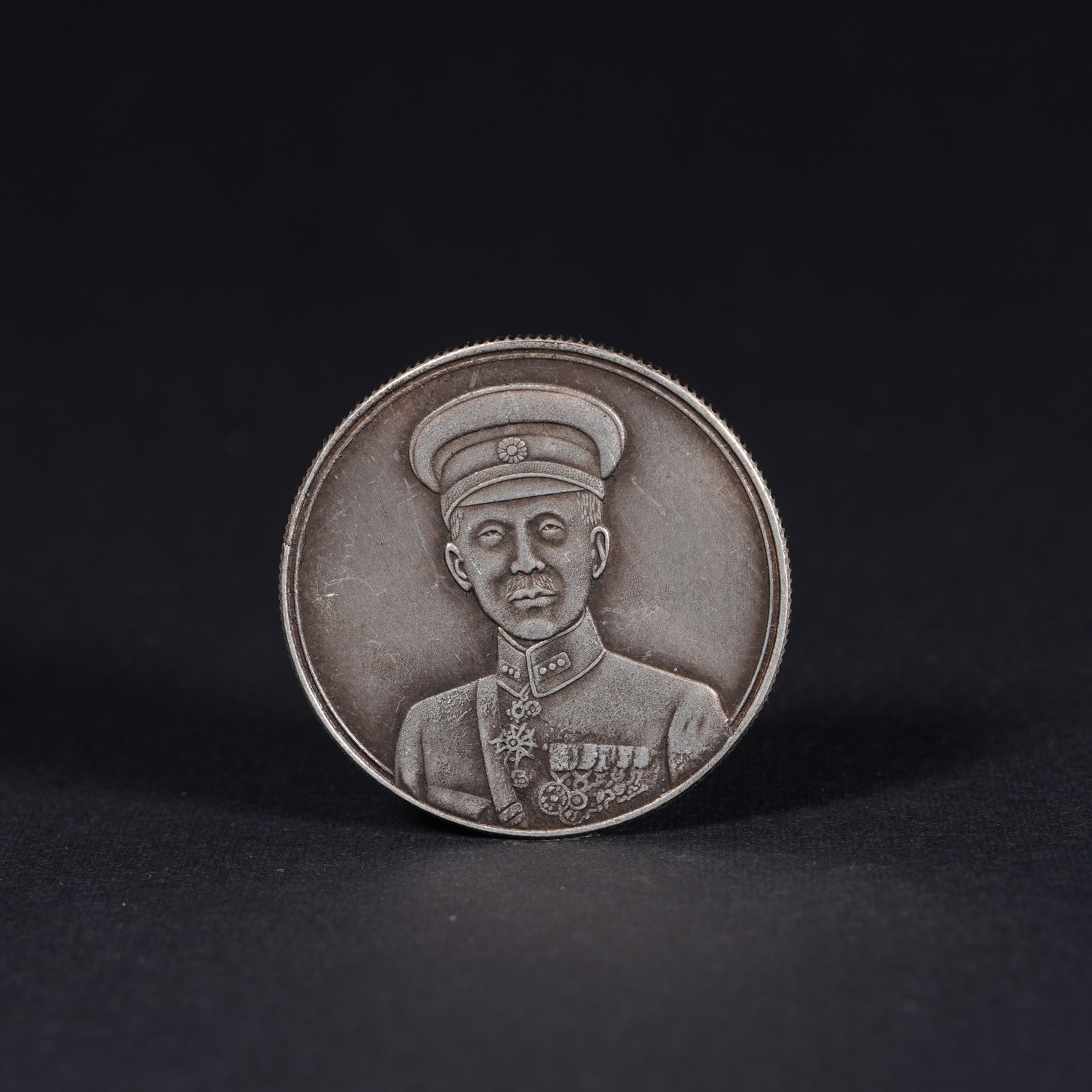 A SILVER DOLLAR COIN: One Silver dollar Coin