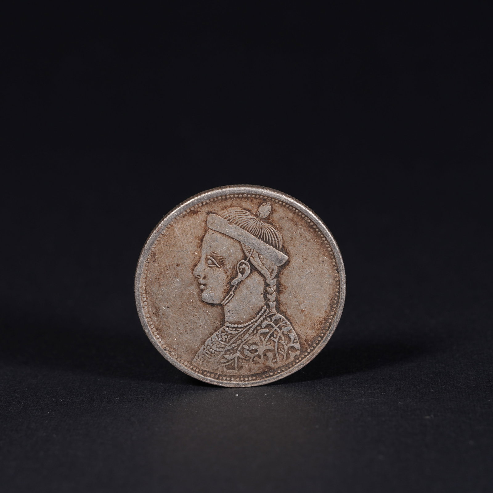 A SILVER DOLLAR COIN: One Silver dollar Coin