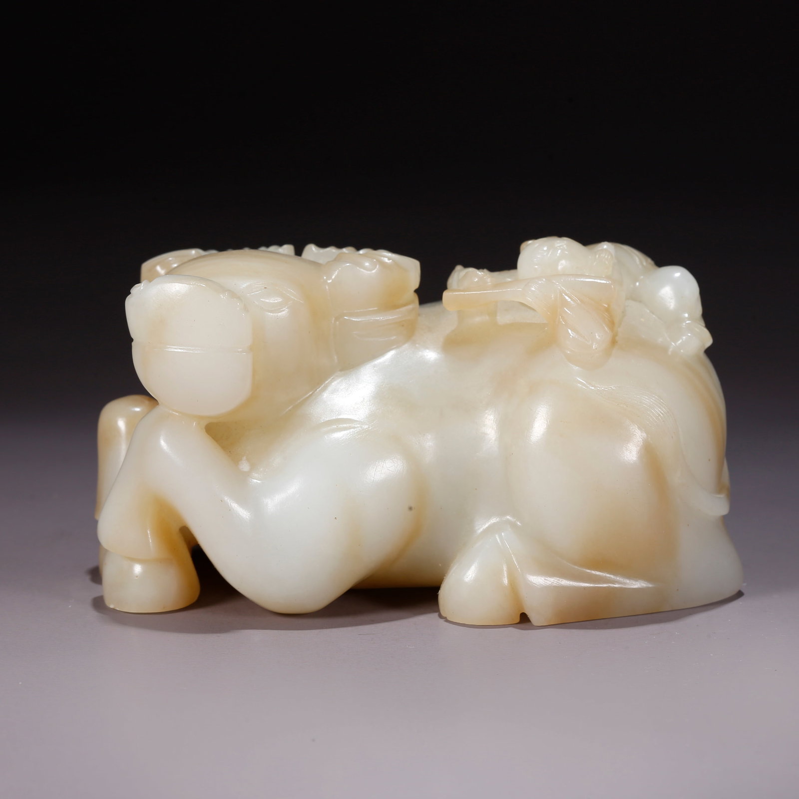 A HETIAN JADE CHILD HERDING OX FIGURINE (1 of 10)