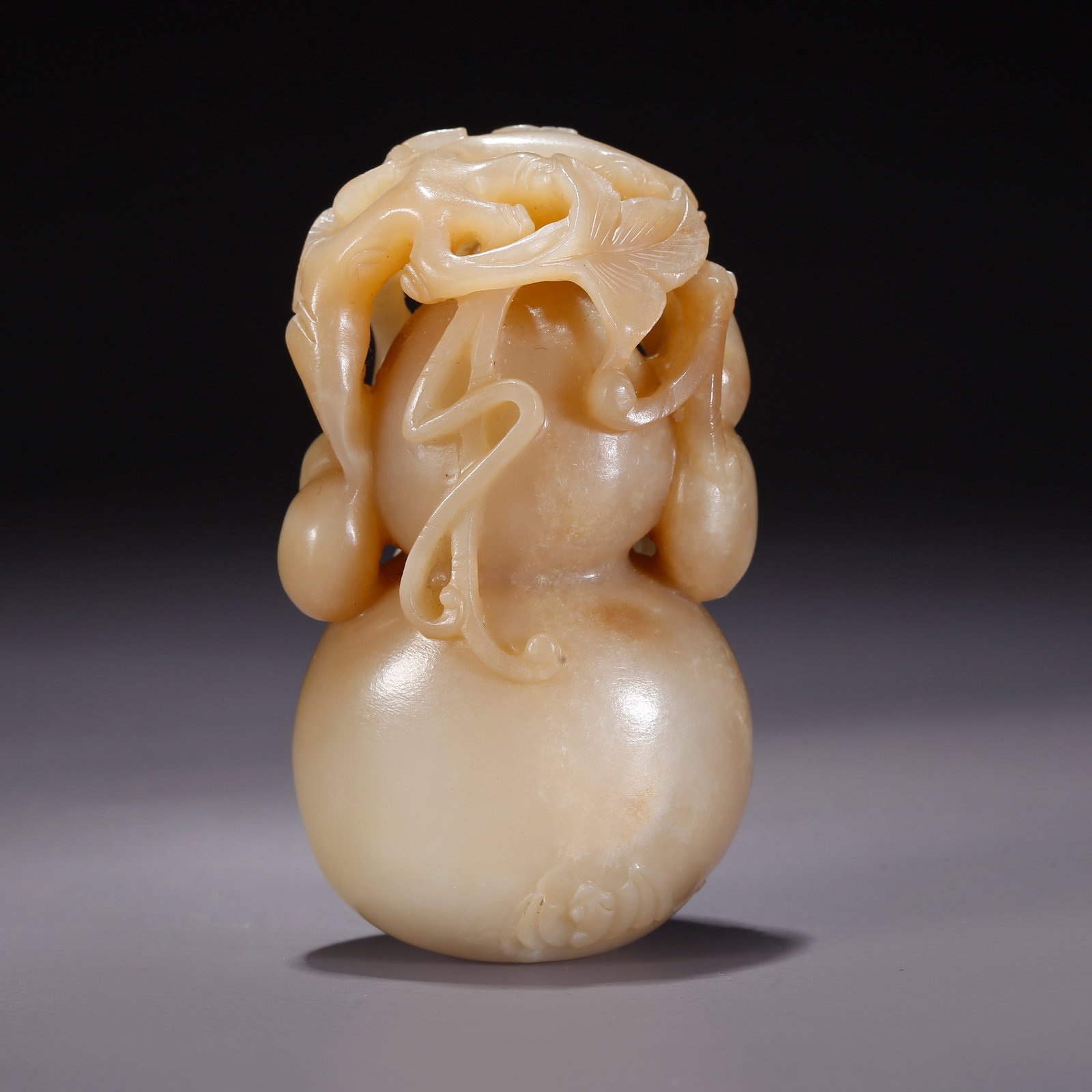 A HETIAN JADE GOURD-SHAPED FIGURINE (1 of 9)
