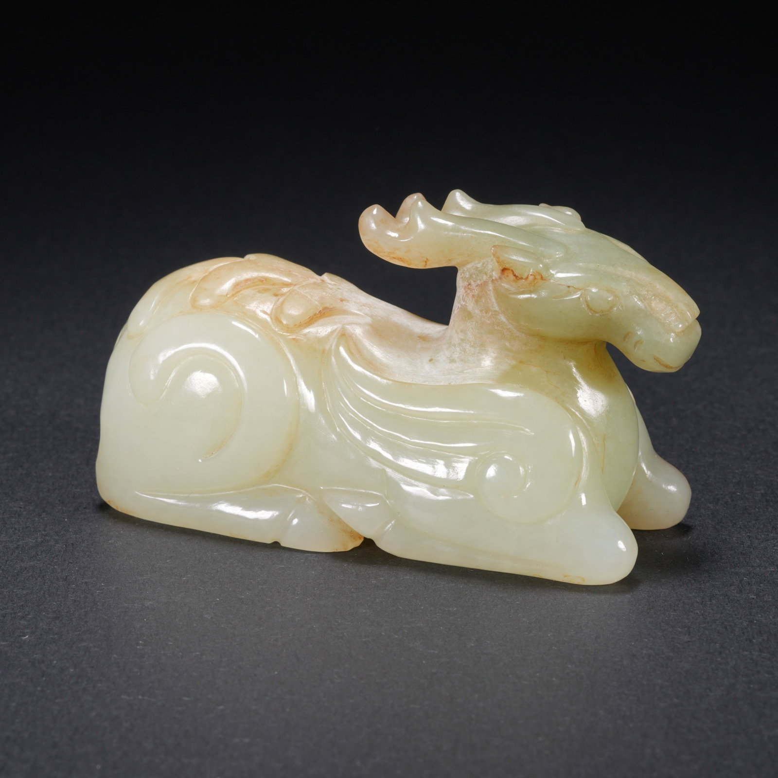 A HETIAN JADE CARVED AUSPICIOUS BEAST FIGURE (1 of 9)